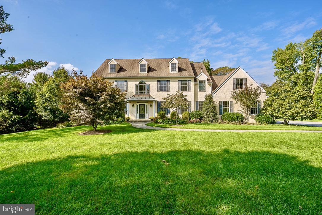 Welcome to this stately and elegant colonial home located in one of Easttown’s most desirable neighborhoods. This semi-custom home is in exceptional condition, maintained with extreme care and love, and exhibits the outstanding quality and detailed attention to. design choices and subsequent renovations and improvements. A wide flagstone walkway leads to the covered front porch, and the quality is immediately apparent upon entering the two story Foyer with handcrafted crown molding, enhanced millwork, and gleaming site finished wide plank hardwood floors. French doors with side and transom lights open into the intimate Living Room with gas fireplace and elegant lighting, and this leads to a hallway with formal Powder Room and Office. The formal DR is across the foyer and leads to the Kitchen through the Butler’s Pantry, and all paths join in the beautiful FR with palladium windows, French doors to patio, wood burning fireplace with marble surround and hand carved mantle. A partial wall separates the FR from the Kitchen and Breakfast area. Abundant natural light flows in through large window and glass doors. Kitchen features light maple Woodmode cabinetry, neutral granite counters and natural stone splash back, SS appliances with 6 burner gas range, a large island with ample storage, deep pantry closet, and entrance to back stairs. Mudroom with double coat closet and family Powder room provides convenient access to the garage. The same beautiful hardwood floors grace all rooms on the first floor, except for the office and Family Room, as all rooms flow together seamlessly. Hardwood floors continue on the second floor in the hallway and MBR suite which boasts of two walk-in closets and an elegant MBA. Two additional BRs enjoy a connecting bath while the fourth BR has an ensuite bath. 2nd floor Laundry Room is conveniently located off the main hallway which also offers two linen closets. The basement is not finished in a formal way, but is immaculate and, with high ceilings and clear sealed concrete floor, it is used frequently as a gathering place for friends. The gardens are as inviting as the house, and the spacious flagstone patio is the perfect spot for enjoying the professionally landscaped fenced yard enhanced with over 75 trees and bushes. This neighborhood enjoys wide, quiet streets for walking and biking, and is in close proximity to the Upper Main Line YMCA, two train stations, and the shops of Paoli. This is a rare opportunity to find a special home in T-E Schools that offers pristine condition, gorgeous level acre yard, convenient location, wide and walkable roads, and available to be settled before the holidays!