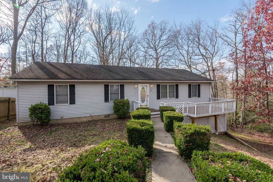 Have your happy holiday at home in this spacious and well-maintained home with new appliances, large rear main-level screened porch, and rear open deck off the lower level with a beautiful view of the trees for three seasons and one season with a lake view.  You'll find PLENTY of parking on the extended, level concrete driveway. Enjoy all that this community has to offer in amenities like the  swimming beaches along the Chesapeake Bay and the lake, as well as the community air strip, playgrounds and more! Unpack, relax, and welcome 2021 in your new space on San Juan.