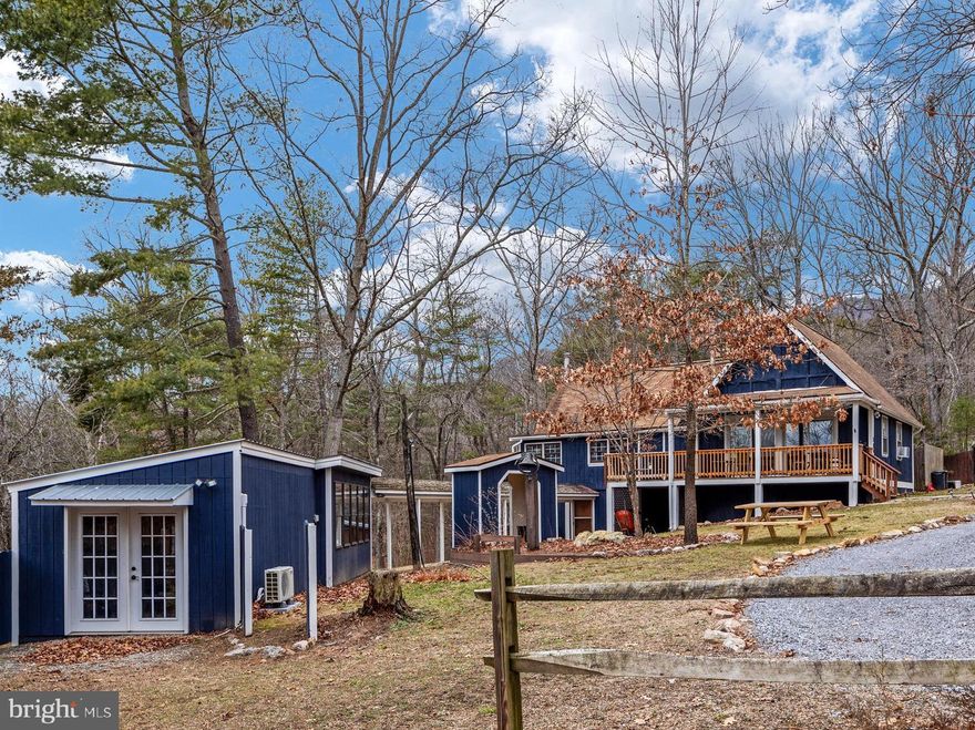 Welcome to Blue Bear Cabin, a turn-key short-term vacation rental located in the coveted Massanutten Forest Subdivision just outside Luray, Virginia. This A-frame style cabin with its additional guesthouse generated $99,567.97 in gross income in 2023 with 291 nights booked. The main floor of the cabin contains a spacious eat-in kitchen, high ceilings, a luxurious living space, a primary bedroom, remodeled bathroom, and an expansive sitting room. Follow the spiral staircase to a loft area where you will find two additional bedrooms with mountain views. The downstairs of the cabin contains another full bathroom, additional living space, a game room, and bunk room. Next, venture over to the guesthouse which contains an additional bunk room and could easily be converted to an office or hobby space. The cabin is situated on a large, 3-acre parcel which offers privacy, seclusion, and peaceful serenity, as well as plenty of room for outdoor activities. A new six-person hot tub with a private deck makes for a perfect spot to enjoy the mountain evenings. Additional outside features including a bubbling stream runs along the rear of the property and there is easy access to downtown Luray. All furnishings convey to make this truly a turnkey property ready to generate income immediately. This cabin is located just a short distance from Luray Caverns, Shenandoah National Park, Kennedy's Peak, the George Washington National Forest, and Massanutten Resort. Hikers, mountain bikers, outdoor enthusiasts, investors, and those just looking to get away from the hustle and bustle, this cabin is for you!