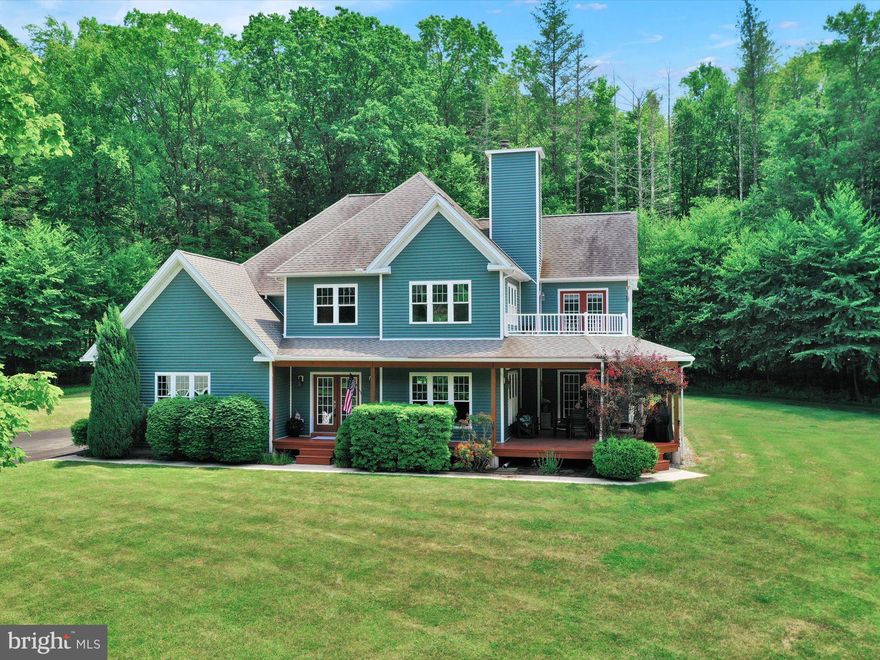 Seeking privacy and relaxation? Look No Further!  This custom built home rests on 21.4 acres of mostly wooded acres surrounded by nature. Clean & Green certification.  Blue Mountain Schools.  Welcoming wrapped around porch to enjoy all seasons.  Spacious entryway with closet. The main level family room is functional  and could also be used as an office or den.  The living room features hardwood floors,  floor to ceiling stone gas fireplace,  large windows for natural light and french doors to the side porch. Large custom-designed cook's kitchen featuring cherry cabinets accented by granite countertops, breakfast top, farm sink with a box window and side door the back deck and yard. Newer kitchen appliances are also included. Main floor laundry and a powder room complete the main floor.  Follow the iron-wrapped stairway to the second floor, wide hallways covered with hardwood floors, sitting or reading area. The primary bedroom is a retreat from the rest of the home, featuring vaulted ceilings, private balcony,  large walk-in closet with access to primary bathroom. The primary bathroom has a spa feel with a Clawfoot tub, separate his & hers sinks, separate shower, tile floors and great views with privacy.  Two bedrooms and a 2nd full bathroom complete the second floor. Full basement with endless possibilities. Two car garage.  Follow the private driveway to this incredible hideaway that offers ample parking, a large above ground pool swimming pavilion. shed, beautiful Pergola.  Plan your summer picnics and take advantage of the fire pit area with horseshoe games! Just a few miles away from major travel routes I-78 & 309. Recreational spots abound with Hawk Mountain Sanctuary, the Appalachian Trail, Schuylkill River & more!
