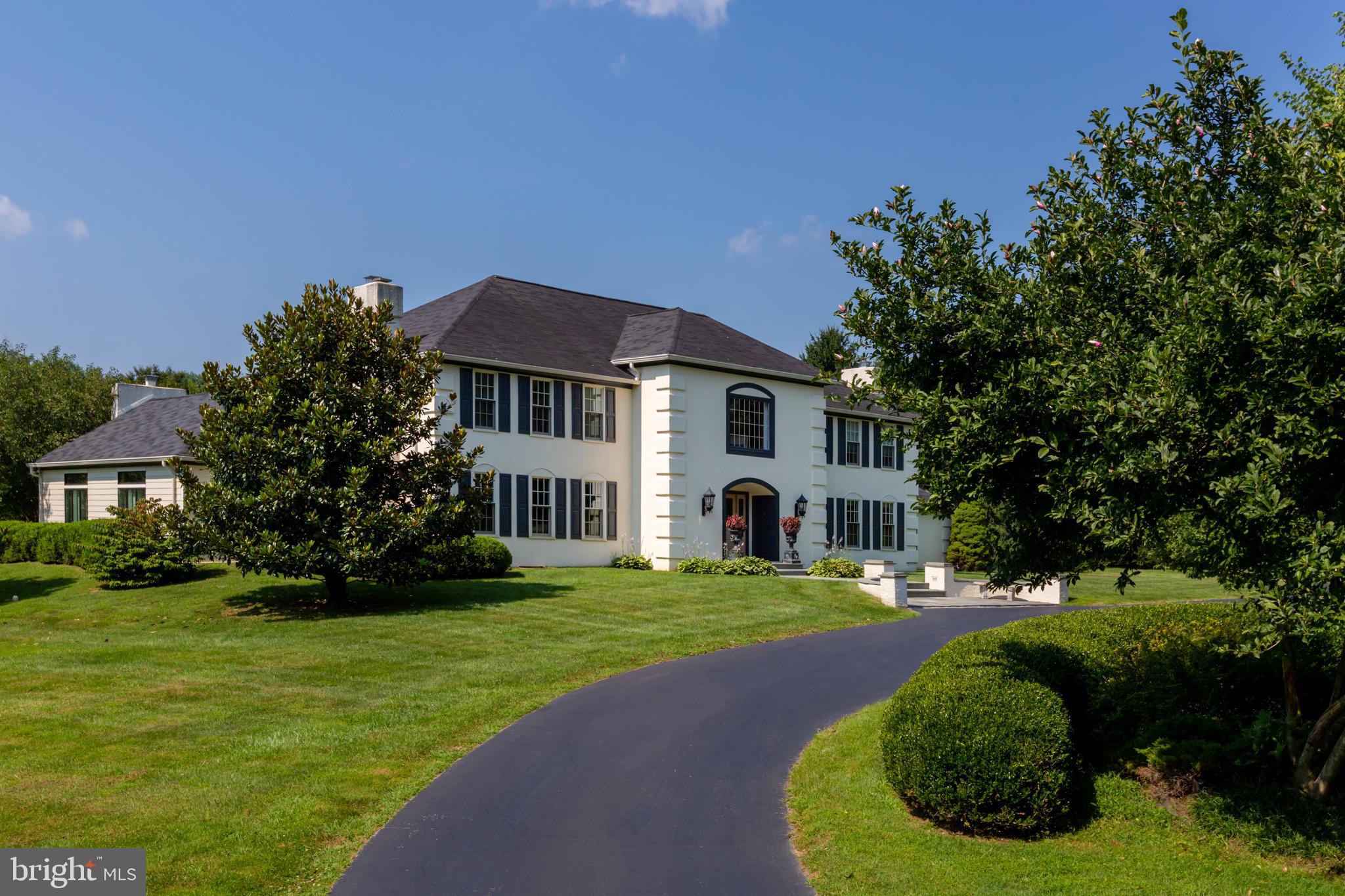 We are happy to accommodate any requests for a virtual tour or additional photos! Tour this lovely property from the comfort of your home. Enjoy resort-style living and entertaining in this elegant, custom-built executive home in a prestigious Radnor Hunt area neighborhood. Greet your guests in the dramatic, light-filled foyer featuring a two-story wall of windows and marble floors. Take in lovely views of the patio, swimming pool, fenced garden, and very private 4+ acre, level lot. The large chef s kitchen features new stainless steel appliances, white cabinetry, a quartz island with seating for a crowd, and a remote-controlled, pop-up TV. Quality appliances include a Sub-Zero refrigerator and wine storage unit, Wolf gas range, new GE Monogram oven, microwave, and warming drawer, new Bosch dishwasher, two sinks and a walk-in pantry. The kitchen has views of the outdoors and opens to a lovely room ideal for socializing, lounging, or informal dining in front of a fireplace. A magnificent great room with twin French doors opening to the pool and patio lends itself to entertaining on any scale. Whether it's a boisterous party or intimate salon, your guests will love congregating in this exceptional room. The large living and dining rooms are sophisticated and inviting, each with its own fireplace. Entertainment features include a seven zone Russound sound system (zones include the garage and outside pool area), a 3D-HD home theater with 110 screen, a built-in 500 bottle wine cabinet, dual beer tap, Brunswick pool table, and home gym with a 75 tv and surround sound. The updated, architect-designed master suite is luxurious, with an adjoining sitting room. The other bedrooms are also en suite. The flexible floor plan offers possibilities for adding bedrooms over the 4-car garage and/or converting the secondary living room into a first floor bedroom. The home's exceptional quality continues outdoors, with its parklike setting and many specimen plantings. The lot offers numerous possibilities for sports enthusiasts, equestrians and gardeners. There is not a prettier place to relax and admire the vista! On a practical note, the four-car heated garage offers plenty of space for vehicles, hobbies and storage. This home and property have been thoughtfully cared for and renovated so that you can spend your time enjoying the good life. You will appreciate the close proximity to Radnor Hunt, Applebrook, White Manor, and Waynesborough Golf Clubs; popular towns of Malvern, Berwyn, and Wayne; Malvern Prep, Episcopal Academy, and Westtown School; and local and Amtrak rail service. Virtual showing available.