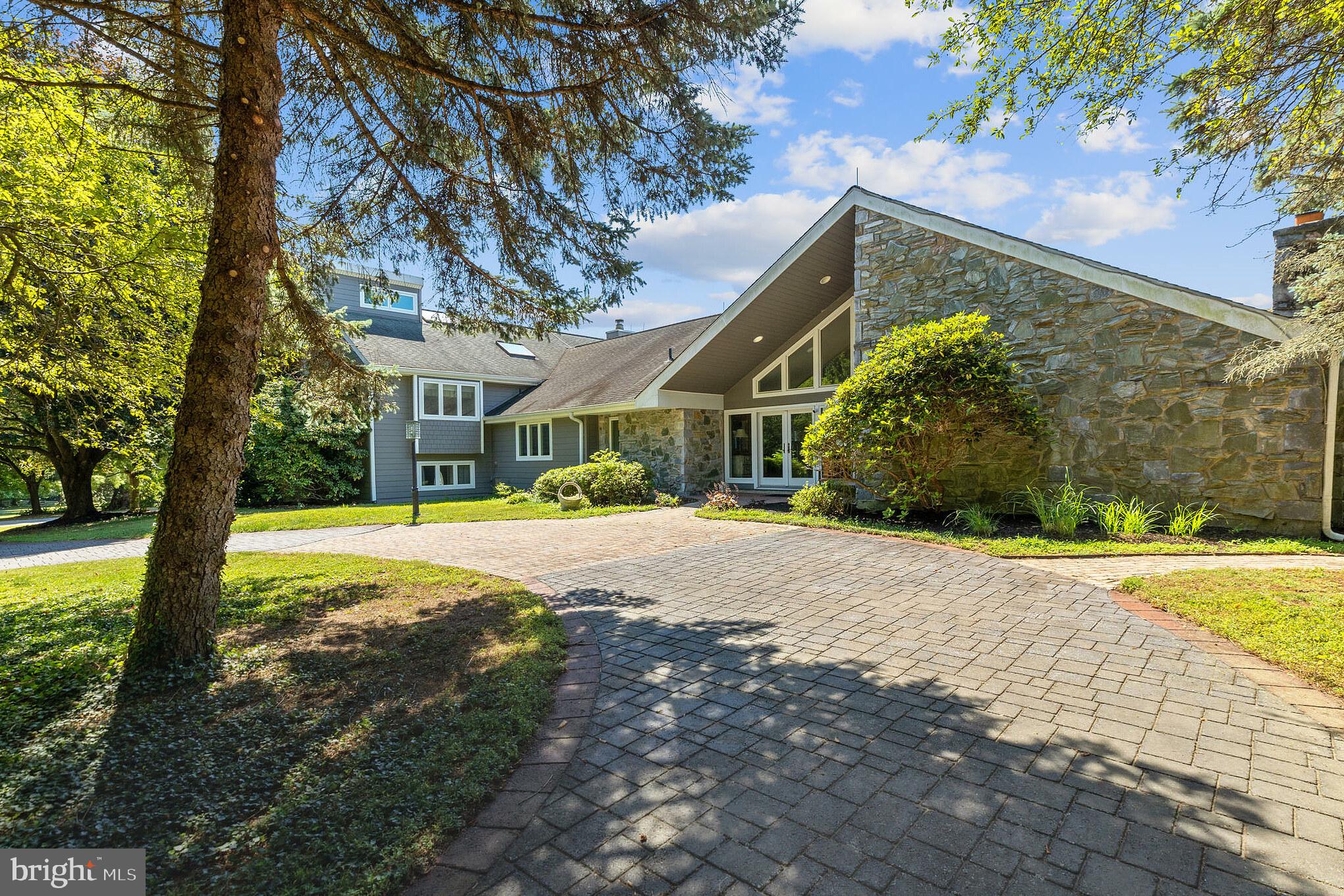 It is extremely rare that a home like this one hits the market with some of the most incredible panoramic views in all of Chester County!! This prestigious estate is perfectly nestled on 10.5 acres of land with in-ground pool, 4 bedrooms, 3 full bathrooms, 2 half bathrooms, 3 fireplaces and a total of 6 garage ports in the Great Valley School District! Take the beautiful tree lined driveway all the way to the front door and walk in to immediately notice that the breathtaking views you saw outside are completely visible no matter where you look from inside as well. The beautiful hardwood floors lead you to the formal living room/den area with stone surround fireplace. Imagine sitting by the fire and enjoying quiet conversation in this stately yet cozy area of the property. The formal dining room is smartly positioned between the kitchen and living room with views of the outdoor oasis and the rolling hills of Malvern. Head over to the dream gourmet kitchen!! Complete with vaulted ceilings, sky lights, THREE kitchen island spaces, and breakfast room, all with those beautiful views of the outside. The family room with fireplace is conveniently located right off of the kitchen, perfect for entertaining. The spacious laundry room and a powder room are also located on the main level of the home. From the family room, head down a small set of stairs to a huge bonus room with half bathroom which is currently set up as a game room/gym. This room could be used as an optional 5th bedroom, an office space, guest room, play room, in law suite, or anything you want it to be! Upstairs, the primary bedroom hosts two huge walk in closets, hardwood floors, the third fireplace, skylights, a deck with hot tub and office with those astounding views! The primary bathroom boasts a tile and glass surround shower with multiple shower heads and separate sinks. There are three additional large bedrooms upstairs, one of which hosts a full bathroom and another that has a loft space which could be used as a play area or office and there is a third full bathroom on this level as well. Ample natural light throughout this home is sure to be noticed. Head outside to the in ground pool and extensive patio area with multiple seating areas to enjoy the quiet surroundings and the extraordinary setting of this estate. An electric fence is already in place for any pets you may have and there is an attached two car garage and a detached, oversized four car garage for an abundance of storage and parking space. The executor of this estate has some helpful (approximate) information about the property which include: around 1996 there was a full renovation of this home which included raising the roof in the kitchen, a full renovation of the kitchen, an installation of new windows , and renovation of the pool area. At some point in the past 5-8 years, the roof was redone, the siding was changed to hardi plank siding, new windows have been installed upstairs, new carpet in the family room/upstairs, and the hardwood in the primary bedroom was added. The basement has a partially finished area, there is also a storage room on the main level as well as an attic/storage area located just outside of the primary bedroom. The 10.5 acre lot might be subdividable for another dwelling but buyers would have to confirm that with the township and go through the necessary steps for that on their own. If you have been looking for a one of a kind gem....this is the one! Located close to the Malvern corporate centers with quick access to major highways, restaurants, shopping, and schools while featuring true privacy, peace, and tranquility with 360 degree all inspiring views and magical sunsets......you will have to see it to believe it!