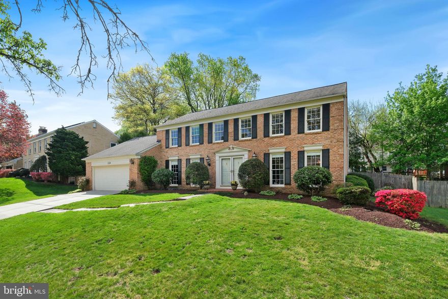 Welcome to this stately brick Colonial - where classic architecture, thoughtful detailing, and a memorable outdoor setting come together -  located in the sought-after Fox Hills West neighborhood of Potomac. Offering 3,909 total square feet over three finished levels with four bedrooms, two full bathrooms, a powder room, and a new roof in 2010. This home combines traditional elegance with comfortable everyday function. A flagstone walkway leads to the double-door entry, setting the tone for an interior defined by hardwood floors, dentil molding, wainscoting, and a warm, timeless feel throughout. A standout feature of the property is the fully fenced backyard retreat. Designed for relaxation or entertaining, it includes an in-ground pool, patio access from the house, and meticulous landscaping.  Anchoring the main level, the kitchen is equipped with stainless steel appliances and opens to a large breakfast area framed by a bay window overlooking the pool and backyard. Just beyond, the family room creates an inviting gathering space with a fireplace set in a brick mantel and French doors that open directly to the patio and pool area. Formal living and dining rooms, a private office with built-ins, a powder room, a mudroom/laundry room with garage access and a side exit complete the main living space.  Upstairs, hardwood flooring continues throughout, creating continuity with the main level. The upper floor includes four bedrooms and two full bathrooms, including a generously sized primary suite with a ceiling fan, walk-in closet, and en-suite bath. The additional bedrooms are well proportioned and adaptable for family, guests, or work-from-home needs. The finished lower level adds valuable flex space, with a wall of deep closets with shelving, and can serve as a game room, playroom, exercise area, or media room. A finished bonus room provides useful additional space for hobbies or other practical needs. Prime location with easy access to dining, shopping, entertainment, parks, and major commuter routes.  Top-rated Montgomery County schools further enhance its appeal. With enduring style, a functional layout, and an exceptional backyard retreat, this home presents a rare opportunity in Fox Hills West.