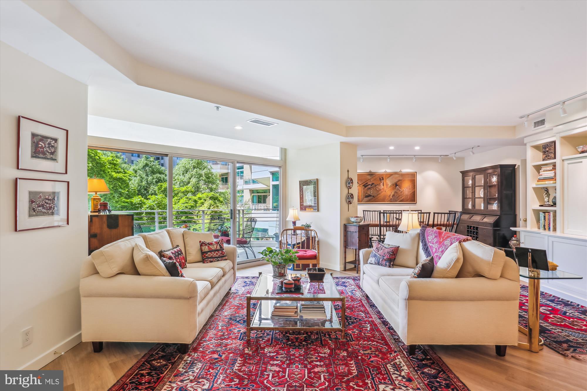 Welcome to this spectacular, light-filled 2,023 sq. ft. condo featuring a balcony with treed views! This residence has been beautifully renovated from top to bottom. It includes a welcoming foyer, an expansive living room with custom built-ins and sliders leading to the balcony, a formal dining room, and a family room/den also with custom built-ins and sliders to the balcony. This den can be converted back into the original second bedroom, which includes a full bath, as the plumbing is still in place. Additionally, there is an expanded powder room and a private office equipped with built-in desk and cabinetry.
The gourmet kitchen boasts premium white shaker-style cabinetry, stone countertops, a ceramic tiled backsplash, and stainless steel appliances. It features a prep island, a breakfast area, and a laundry closet.
The primary bedroom suite is a highlight, showcasing custom built-ins, a walk-in closet, and two double wall closets. The renovated spa-like bathroom offers an oversized shower, a dual sink vanity, a linen closet, and ample cabinet storage space. Throughout the condo, you will find custom shades and window treatments, beautiful wide plank flooring, and exquisite lighting and fixtures.
This sale includes two garage parking spaces (G2-200/201) and additional storage (G3-40). Pets up to 25lbs are welcome!!
Experience elegant, resort-like living in the most luxurious complex and gated community in Friendship Heights, situated on over 17 acres. Amenities include a gatehouse, 24-hour valet service, concierge/front desk, 24-hour security, and a three-story clubhouse featuring heated indoor and outdoor pools, party rooms, a state-of-the-art fitness center, a racquetball court, billiards and ping pong rooms, an aerobics room, an art/hobby room, and tennis/pickleball courts. The grounds are lushly landscaped with walking paths for your enjoyment.
Shops, dining, grocery stores, and the Friendship Heights Metro station are all just a leisurely stroll away.