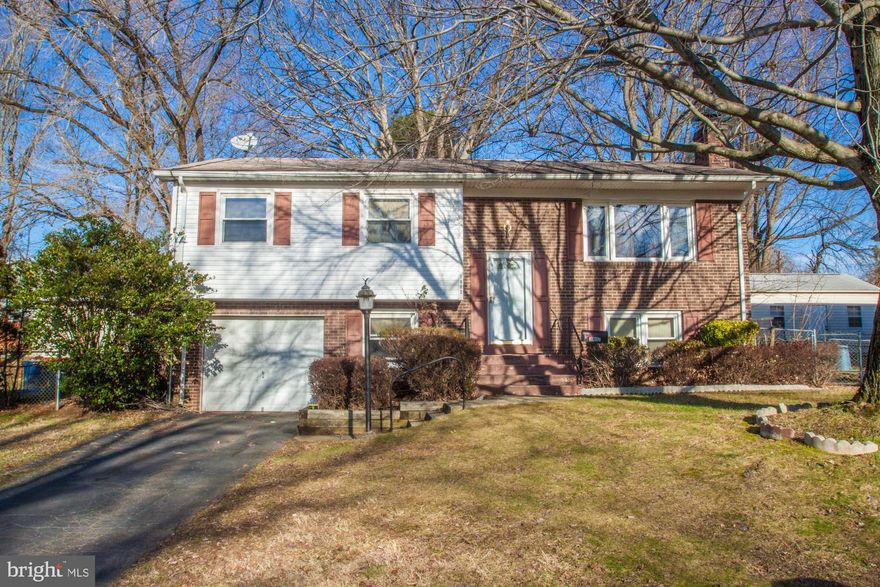 Spacious two level four bedroom plus 1   +   split foyer in need of a little tender loving care!  Lovely open floor plan on the upper level with hardwood floors and dining room opening onto large deck perfect for outdoor entertaining.  The large paneled lower level  family room features a floor-to-ceiling brick wall with fireplace.  This wonderful rom is perfect for family gatherings, or a play room, rec room or exercise room.  Additional features include two ceiling fans, plentiful storage plus attached one car garage.  House is being sol strictly  as is , and the price reflects it!  Minutes to I-95, Potomac Mills, shopping and restaurants.