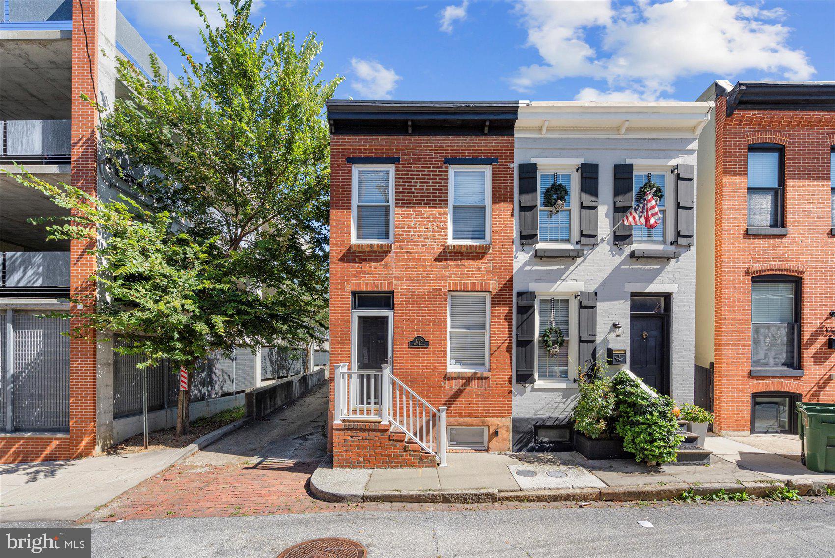 Charming 3BR/2BA end of group townhome located on a quiet side street in the heart of the Federal Hill Historic District. Make your way to the door into the living room featuring beautiful hardwood floors and a dining space with a brick fireplace.  The kitchen is in the rear with stainless steel appliances and tons of cabinetry and counterspace. Upstairs offers two large bedrooms, each with large closet space and a newly updated full bathroom. The rear bedroom features a privacy balcony, perfect for relaxing in the evenings. The lower level offers an additional bedroom and an updated full bathroom. The laundry room can also be found in the lower level equipped with a washer/dryer. A concrete patio completes the exterior, great for hosting family and friends. Imagine all this and located less than 2 blocks away from  numerous restaurants and bars and only a 10 to 15 minute walk to the Inner Harbor, Federal Hill Park and M&T Stadium!