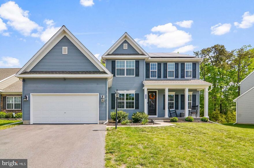 Incredible farmhouse colonial in fantastic community setting!  Only three years young and still looks and feels like a new home!  With nearly 3,000 square feet of finished space above grade, you will have plenty of space for living and entertaining.  Wide open and spacious floor plan with open foyer, first floor office, half bath, formal dining area.  The entire back of the home is a large family room and gourmet kitchen with breakfast nook, oversized island/breakfast bar, separate beverage center, quartz counters, 42" white cabinets, ceramic tile back splash, and stainless appliances.  This model has the first floor primary bedroom suite with spacious bedroom area, two walk-in closets and a spa-like bath with double vanity and huge walk-in shower.   Second floor features three bedrooms, a full bathroom and an open loft area.  Loft would make a great home office, gym, playroom or could be converted to a fifth bedroom if desired.  Very large lower level with rough-in for full bath and ready for your vision to create the ultimate family room, media room, home gym or anything else you may need.  Fantastic lot backing to wooded conservation area - part of this property does go into the conservation area.  Added luxury of very low electricity costs due to owned (not leased) solar panels.  Two car attached garage with auto-opener. 
Maintenance free vinyl exterior.