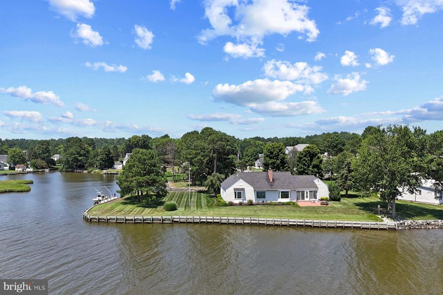 Welcome to 12264 Dixie Drive! A rare and exceptional Riverfront property located on a spacious bulkheaded point. This remarkable property features expansive southern exposure and breathtaking panoramic water views from nearly every room in the home!   The water enthusiast's will love the private dock, with the ability to keep multiple boats and watercraft.  This is a truly one-of-a-kind offering that combines tranquility, space, and unmatched access to the water. Whether you’re a boater, nature lover, or someone seeking a serene waterfront lifestyle, this property delivers it all.
The single-level home features 3 bedrooms and 2.5 bathrooms. The spacious primary bedroom includes a picture window with stunning water views. Two additional bedrooms share a full bath, providing comfortable accommodations for family or guests. A bright, functional, and generously sized kitchen flows into the formal dining area, ideal for entertaining. The dual-sided fireplace connects the living room and family room, creating a warm and cozy ambiance in both spaces. The living room, with large windows framing the water, opens directly into a sunroom that’s perfect for enjoying year-round sunsets over the St Martin's River.  Additional highlights include a dedicated laundry area, a half bath, an attached 2-car garage, central vacuum system, and ample outdoor space with a fantastic yard—perfect for al fresco dining or simply unwinding by the water. For added peace of mind, the home also features a propane generator with a buried fuel tank.
Included in the sale is the adjacent additional lot of 0.30 acres adds even more waterfront footage and opens the door for future expansion or outdoor living possibilities, creating a 1-acre corner property.
This is a rare opportunity to own a  waterfront estate with unmatched views and exceptional outdoor living potential. Located in the community of Holiday Harbor with easy access to Ocean City and the Delaware beaches.  Schedule your private tour today and discover the beauty  of 12264 Dixie Drive!