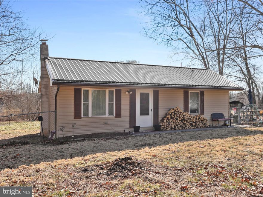 *HIGHEST & BEST OFFERS DUE BY TUESDAY, MAR. 11 by 12PM*
Charming and updated single-family home on a spacious 1.25-acre lot in Bunker Hill! This 2-bedroom, 1-bathroom home offers cozy living with 864 square feet of well-maintained space. Recent updates include a new metal roof, new vinyl siding, and new windows, ensuring a modern, energy-efficient home. Enjoy the warmth of multiple heating options, including baseboard heating and a wood-burning stove, with ceiling fans for added comfort. The home features a crawl space foundation, an electric baseboard heating system, and a septic system for peace of mind. Set on a peaceful rural lot, this home is perfect for anyone seeking a serene lifestyle with convenient access to local amenities. Don't miss the opportunity to make this home yours!