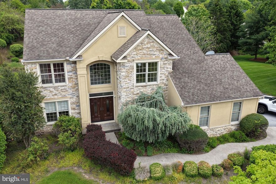 Welcome home to Stoney Run, one of Hummelstown’s most loved neighborhoods, known for its handsome homes, mature surroundings, and tucked-away, private-oasis feel. Set on a generous .55-acre corner lot in desirable Derry Township, this home offers the space, setting, and flexibility that are getting harder to find — more greenery, more privacy, and more room to run, play, garden, entertain, or simply enjoy.
Step inside to a bright, open layout designed for real life: entertaining, hosting, working, relaxing, and giving everyone room to spread out. The main level features warm flooring, detailed trim work, arched openings, a grand vaulted entryway, and an elegant spiral staircase that gives the home a memorable first impression. The living spaces feel spacious and welcoming, with a fireplace adding just the right amount of cozy.
The kitchen is a standout, built for both function and gathering, with granite countertops, gas cooking, double wall ovens, abundant cabinetry, a center island, and plenty of prep space. The bright breakfast nook, surrounded by windows and finished with vaulted ceilings, is the perfect everyday spot for coffee, quick meals, homework, or lingering a little longer in the morning. Translation: weekday dinners, holiday cooking, snack spreads, you name it — this kitchen can handle it.
Upstairs, you’ll find four spacious bedrooms, including a primary suite that feels like a true retreat with a tray ceiling, generous layout, ample closet space, and a private bath featuring a soaking tub, separate shower, and glass-block window. Three of the bedrooms include walk-in closets, giving the home excellent storage and day-to-day functionality.
The finished lower level adds serious bonus space with a large recreation area, built-in wet bar/cabinetry, bathroom, cedar closet, game room potential, and extra storage — perfect for entertaining, movie nights, hobbies, guests, or simply creating a second hangout space.
Out back, the screened porch may quickly become the favorite spot in the house, overlooking the fully fenced yard, patio area, mature greenery, and plenty of open lawn. Morning coffee, evening unwinding, summer dinners, sounds of running & playing, quiet weekends — this yard gives you options.
With timeless architectural details, flexible indoor and outdoor living spaces, first-floor laundry, a finished lower level, a large private lot, and a sought-after Stoney Run location just minutes from Hershey Medical Center, downtown Hershey, trails, parks, shopping, dining, and major routes, this one checks the boxes that actually matter.