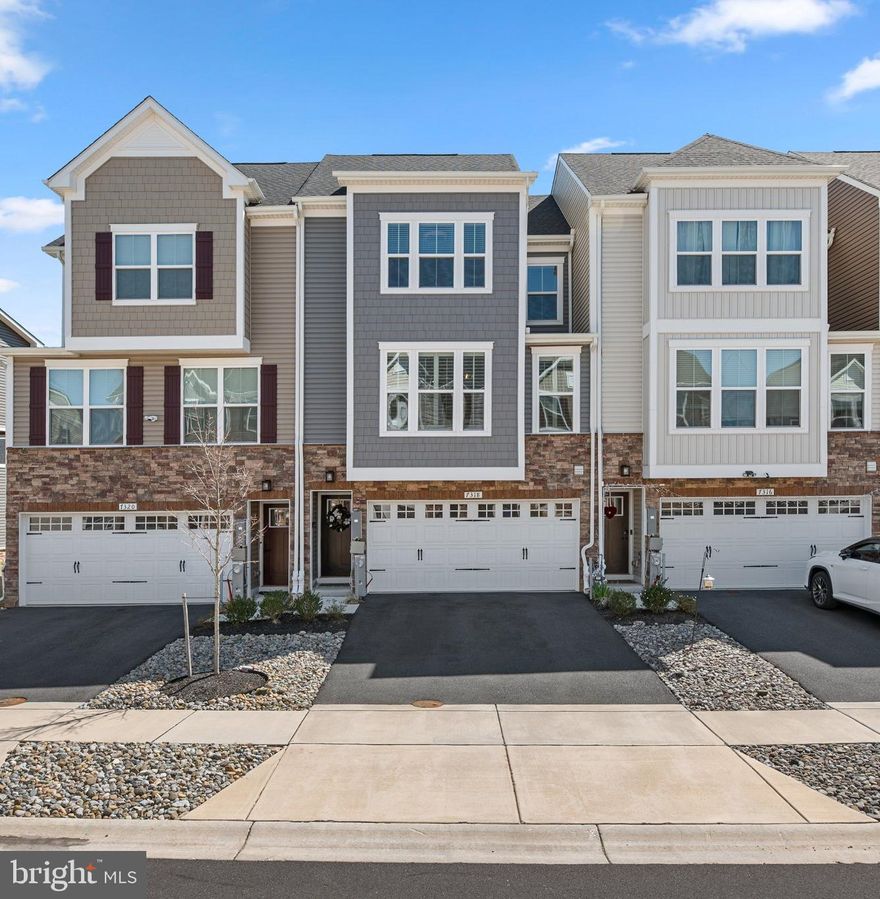 Welcome to 7318 Isabella Road, a stunning 3-bedroom, 2 full and 2 half-bathroom townhome in North Laurel's desirable Wellington Farms community. Built just 2.5 years ago, this immaculate residence offers over 2,000 square feet of thoughtfully designed living space across three levels.

The lower level features a welcoming entrance, a carpeted recreation room with a modern accent wall, and access to the fully fenced backyard. An updated half bathroom showcases modern LVP flooring and a stylish shiplap accent wall. Access to the 2-car garage is also located on this level.

Upstairs, the main level showcases an open floor plan perfect for entertaining, featuring a light-filled living room with large windows. The kitchen is sure to impress with quartz countertops, stainless steel appliances, abundant cabinet storage, and a spacious island with additional seating. A sliding door leads to an enclosed deck, creating a seamless indoor/outdoor entertainment space. The dining area can accommodate a large table, and a convenient half bath completes this level.

Upstairs, you'll find three generously sized bedrooms with plush carpet and ceiling fans. The primary suite boasts a private bathroom with dual vanity and oversized shower. The hall in the upper level includes a full bathroom and a conveniently located laundry room.

The current owner has made several upgrades, including fully repainting the interior of the home, installing custom window shutters, a backyard privacy fence, a custom closet system in the bedroom, and an electric solar shade on the enclosed deck.

Wellington Farms residents enjoy access to a community clubhouse and pool. The neighborhood is ideally situated just minutes from I-95, Route 29, and Route 32, making commutes to both Washington DC and Baltimore convenient.

The property is a short drive to the vibrant Maple Lawn district's shopping and dining options. Howard County's abundant parks and trails provide endless recreational opportunities, with Hammond Park, Scotts Cove, and Howard Duckett Watershed all nearby.

This low-maintenance townhome combines modern finishes, thoughtful design, and an ideal location—perfect for today's lifestyle. Don't miss this opportunity to own in one of Howard County's most desirable communities.