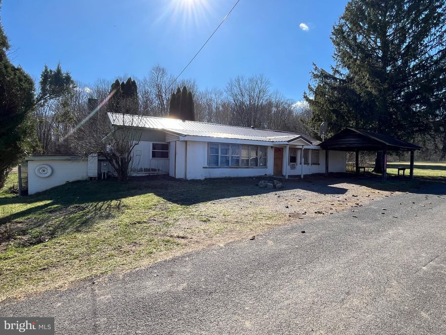 Trailer located on a  flat 1.21 acre lot with no city taxes.  With some sweat equity, this would make a great home or investment property.