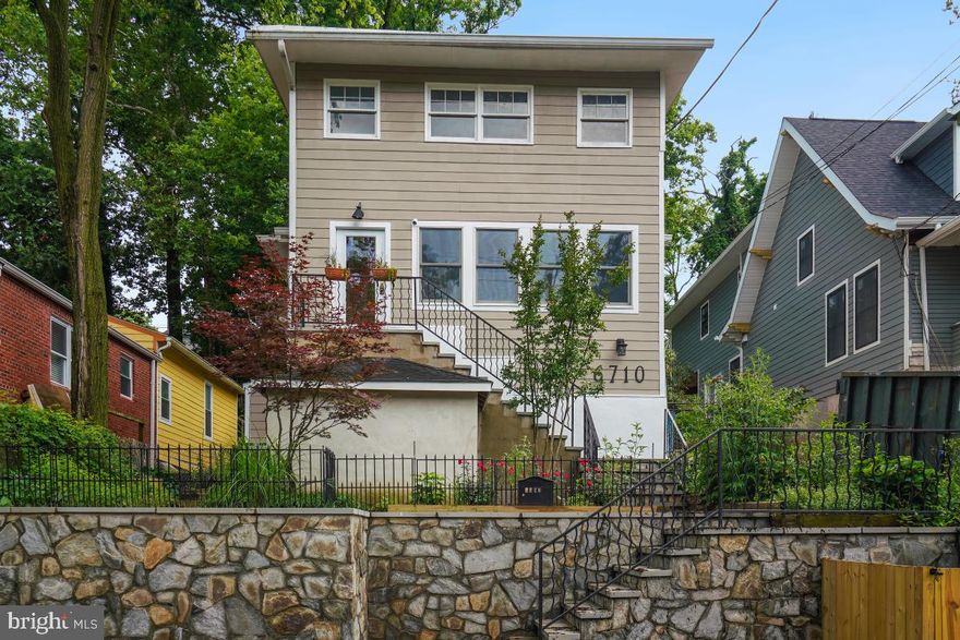 Welcome to 6710 Westmoreland Avenue! Originally built in 1912, this expanded bungalow has an incredible chef’s kitchen, wonderful architectural details including modern bead board accents, wood flooring, custom millwork, barn doors, recessed lighting, modern ceiling fans, three split A/C units, and excellent outdoor space with extensive stone hardscaping, an a robust in-law/ au pair suite. This extraordinary home includes a versatile front sunroom with a beadboard ceiling and two ceiling fans. The home’s captivating living / dining room boasts wood flooring, a built-in China cabinet, a decorative fireplace, recessed and sconce lighting. You will be surprised by the large and thoughtfully designed gourmet kitchen. This chef’s kitchen features extensive granite counters, vibrant glass tile backsplash and walls, stainless steel appliances, a Haier refrigerator, a professional grade Gaggenau oven, an Electrolux 6 burner gas cook-top with a Cavaliere range hood, a breakfast bar, a pantry, and incredible prep space. The kitchen opens to a light-filled breakfast room with access to the enchanting stone patio. Off the kitchen is a large laundry / storage room. The main level is complete with a bright bedroom, an office nook, and a renovated bathroom with a vessel sink and an incredible shower with multiple jets and a built-in bench. As you proceed to the second floor there is a gorgeous mural painted by a local artist. The upper level has two bedrooms, two beautifully renovated bathrooms, and a wonderful family room. The primary bedroom offers recessed lighting, a modern ceiling fan, original wood flooring, tree-top views, and a wonderful walk-in closet with custom cubbies. The redesigned primary bathroom has a state-of-the-art steam shower with multiple jets, an accent niche, and a heated towel rack. 

The separate space features high ceilings and has its own entrance. It includes a living room area, full kitchen, two bedrooms, a full bathroom, and laundry hook-up. The home is situated on a lot featuring gorgeous stone retaining walls, a picturesque stone patio with built-in display ledges, and a front parking surface!  

The ideal location: close to Takoma Urban Park, Takoma Park restaurants and shops and just 0.5 miles to the Takoma Metro Station! Enjoy living in eclectic Takoma Park; the location offers all the allure and convenience of this very special area.  Relish the warm sense of community as well as ready access to shopping, restaurants, the farmer’s market, and entertainment in both Takoma Park and wonderful, downtown Silver Spring. See you there!