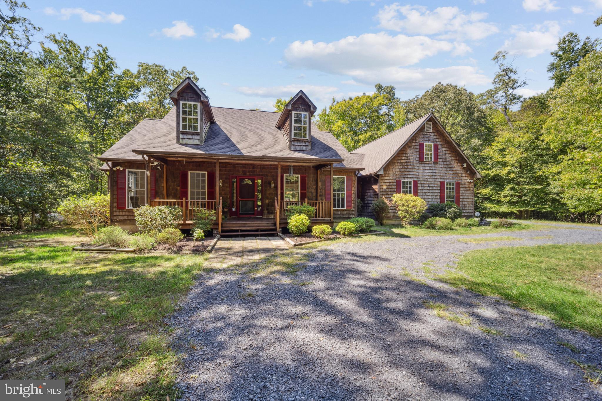 A new roof and a new furnace now further contribute to the the value and attractiveness of this 3 bedroom, 2 bath traditional style home sited on 5 private acres in the sought-after historic area of Moyaone Reserve. An inviting and center hall entry is flanked on either side by a gracious living and spacious dining room with crown moldings and wainscoting and window placement that make each room bright and beautiful! This entry hall then opens into a dramatic family room with cathedral ceiling, symmetrically arranged doors leading to a screened porch and an inviting back yard deck with custom planters and a view of the beautiful natural "kingdom" that surrounds this residence.
An owner's suite has a large bath with a new state-of-the-art shower and a double sink vanity. A large walk-in closet will meet one's "all season" apparel needs. The bedroom has double exposure to enjoy the beauty of the natural surroundings and its own door leading to the backyard deck.
Two other bedrooms (or a second suite with bedroom and study) are located on the opposite side of the home. One room offers custom built-ins for an at-home office space. A full hall bath in between these rooms is well-designed with a large closet and an attractive window. Comfortable living at its best!! Two of the bedrooms have new carpet; the hardwoods in the common area are traditional and most attractive. An eat-in kitchen, a first floor spacious laundry room (washer, dryer and sink with custom built-ins) pantry, a basement entry and an entrance to the 2-car side-loading garage complete this level.
The lower level is a walk-out and has both windows and a sliding glass door to provide plenty of daylight exposure. The first room at the bottom of the stairs is finished; a large open area served as a workshop and at-home office and storage space for the current owner.
A separate utility room, storage area and a one car garage are behind closed doors off the large open area. There is also a fire-retardant system in this home.
This house was custom-built for these owners in 2000 and the original plans are available for future owner's review. This home is about 20 miles from the U.S. Capitol and the view from Mount Vernon across the River was meant to remain free of visible development by both locations. Careful planning and legislation have made this possible.
This home can be either a weekend getaway or a permanent residence for its new owners; whatever its use, the natural beauty and historicity remain intact and offer residents many opportunities for local research, service, preservation and environmental education. There are scenic easements, restrictions and covenants that protect that history and further development in the Reserve. Information on these and Piscataway Park and the Alice Ferguson Foundation are available at the residence. There is an HOA ($820 a year) which does include use of the pool and community recreation facilities.
Piscataway Park (a 5000 acre National Park) is comprised of 7 entities: National Colonial Farm, Hard Bargain Farm, Farmington Landing, Fort Washington Marine, Accokeek Creek Park and Marshal Hall. Moyaone Reserve is geographically divided into 7 sections each uniquely named with different elevations and views. Community recreation, walk trails and parks abound in the area.
Enjoy your tour of this one-owner custom-designed home!