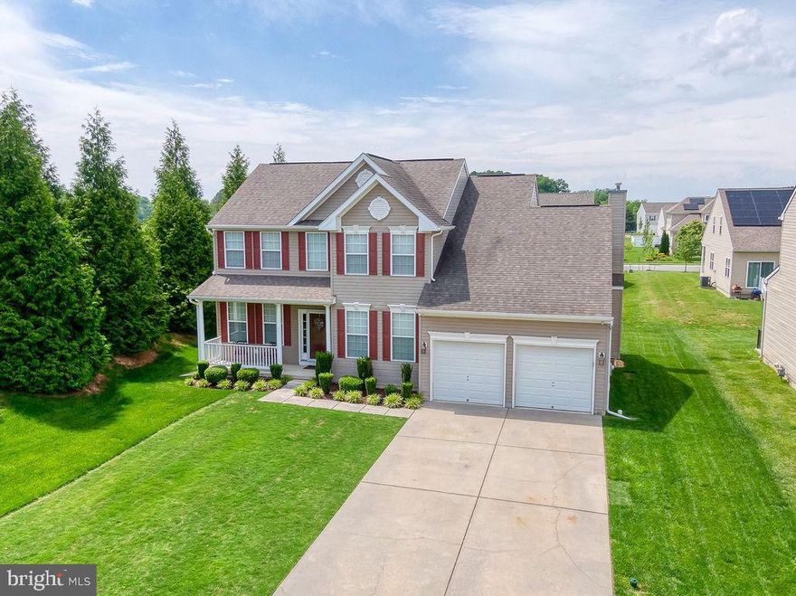 Stately 4BR/2.5BA Colonial located in the desirable neighborhood of Longboat Estates. Park in the double-wide driveway, walk past lush green lawns and pristine landscaping and make your way to the covered front porch of your forever home. Open the door into a bright entry with hardwood flooring and an open view of the second floor. To the right of the entry is a home office with privacy doors, a half bath, laundry, and access to the two-car garage featuring an epoxy floor, cabinets, and heat. The spacious living room beams with natural light and features luxury flooring that carries through into the dining room and heart of the home. The open concept space every homeowner is seeking can be found in the spacious family room beaming with natural light and boasting a gas fireplace. A breakfast room that is open to the kitchen featuring plenty of shaker cabinets, slate appliances, a double stainless sink under a window, a glass tiled backsplash, and a center island with a stunning custom live edge wood countertop. On the second floor is a large primary suite with a spacious walk-in closet and private ensuite featuring a double sink vanity, walk-in shower and large soaking tub. Three sizable bedrooms with spacious closets and a full bath completes this living floor. From the sliding doors in the breakfast room step outside to a sea of green space and a cozy custom built fire pit surrounded by a raised stone wall. This home is move-in ready with so much to offer new homeowners including a smart thermostat, security system, and access to a community pool and dock. Imagine all this and in close proximity to shopping, restaurants, and commuter routes.