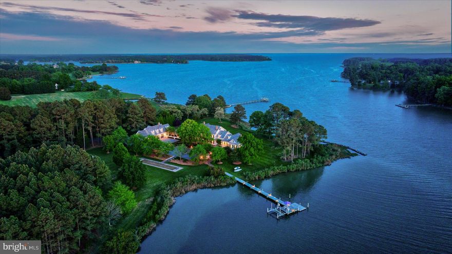 Irish Creek Waterfront Estate
Set along more than 1,000 +/- feet of pristine, navigable waterfront on Irish Creek, this remarkable 22.14 +/- acre waterfront estate captures the very essence of luxury living on Maryland’s Eastern Shore. Surrounded by sweeping southwest-facing water views and unspoiled natural beauty, the property offers exceptional privacy and scale just minutes from the charming towns of Easton and St. Michaels.

Approached by a long, private paved drive, the stately Colonial residence blends timeless architecture with comfortable sophistication, designed for both elegant entertaining and relaxed waterfront living. Inside, refined interiors feature rich hardwood flooring, extensive crown molding, custom built-ins, and four wood-burning fireplaces, creating warm gathering spaces throughout the home.

The main level is thoughtfully designed for hosting and everyday living, with gracious formal and informal spaces that flow effortlessly together. A formal dining room, expansive living and family rooms, and a well-appointed kitchen with island and pantry create the perfect setting for gatherings with family and friends. The main-level primary suite offers a peaceful retreat with its own fireplace, walk-in closet, and spa-inspired bath. Upstairs, three additional bedrooms and two full baths comfortably accommodate guests for extended weekends on the Shore.

Outdoors, the estate unfolds as a private waterfront retreat designed for unforgettable weekends and celebrations. Spend warm summer days by the Gunite pool and outdoor spa, gather around the built-in fire pit at sunset, or enjoy a friendly match on the bocce court. A tranquil pond and expansive grounds enhance the sense of serenity, while the vaulted three-season porch provides the perfect vantage point for watching boats drift by and taking in the breathtaking evening sunsets over Irish Creek.

The property is exceptionally well-suited for hosting, with a charming pool house and a separate two-bedroom guest apartment above the detached four-car side-entry garage—ideal for visiting family, weekend guests, or extended stays.

Located in the coveted Royal Oak waterfront community, and within easy reach of Easton, St. Michaels, and the Chesapeake Bay, this extraordinary offering is less than two hours from Washington, D.C., Baltimore, and Philadelphia, making it the perfect luxury retreat for weekend escapes or year-round living on the Eastern Shore.

Here, life slows down—boating at sunset, long summer weekends with family and friends, and the timeless beauty of Chesapeake Bay living.