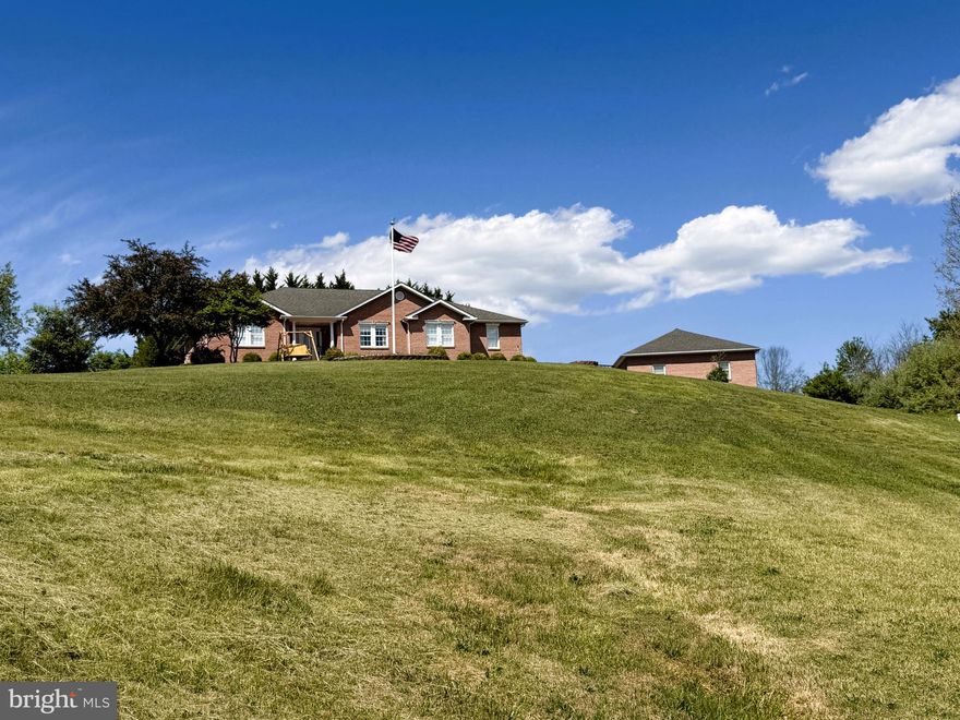 SINGLE LEVEL SOLID BRICK RANCHER ON MAGNIFICENT 1.9 ACRE LOT IN THE HEART OF CAPON BRIDGE.....PAVED STREETS LEAD YOU TO THIS SOLID BRICK FORTRESS, UPON ARRIVAL THE LONG RANGE VIEWS GRAB YOUR ATTENTION IMMEDIATELY! THE HOME; BUILT IN 2006, OFFERS DESIRABLE SINGLE LEVEL LIVING....OVER 1900 SQ FT OF LIVING SPACE AND OVER 2200 SQ FT UNDER ROOF, IT'S SPACIOUS TO SAY THE LEAST. HARDWOOD & CERAMIC TILE FLOORS, CHERRY CABINETS GALORE, JENN AIR DOWNDRAFT COOK TOP, CENTRAL VAC, HUGE LAUNDRY ROOM, JETTED TUB AND OFFICE COULD BE USED AS A 4TH BEDROOM IF NEEDED. A THOUGHTFULLY DESIGNED HOME THAT LOADED WITH FEATURES & BENEFITS. MOTOR HEAD? GREASE MONKEY? TONS OF GARAGE SPACE.....32X28 2 CAR DETACHED GARAGE, 1 CAR ATTACHED GARAGE AND ADORABLE 12X12 GARAGE FOR YOUR MOWER. TREES & PLANTINGS PROVIDE PRIVACY FOR THE OUTDOOR LIVING SPACE.....SOAK IN THE HOT TUB WHILE SOAKING IN THE MOUNTAIN VIEWS BY DAY AND STARS & CITY LIGHTS BY NIGHT. THE LOCATION....TOUGH TO BEAT, LESS THAN A MILE FROM THE CENTER OF THE THRIVING VILLAGE OF CAPON BRIDGE, PRACTICALLY WITHIN WALKING DISTANCE OF SCHOOLS AND ONLY 20 MINUTES FROM WINCHESTER, VA. AS AN ADDED BONUS, IT'S ONLY A 3 MINUTE WALK TO PRIVATE COMMUNITY ACCESS ON THE CACAPON RIVER. IF YOU WERE STARTING FROM SCRATCH, AT TODAYS COSTS, YOU'D BE WELL OVER 700K TO REPLICATE THE STRUCTURES AND THE LOT WOULD BE PUSHING 100K. AT 435K, THIS PROPERTY IS PRICED AT NEARLY HALF THE REPLICATION COST! SOMEONE IS GONNA GET A GREAT DEAL AND IT MIGHT AS WELL BE YOU! SO MUCH TO OFFER, SUCH A GREAT LOCATION.....THIS ONE'S A NO BRAINER!