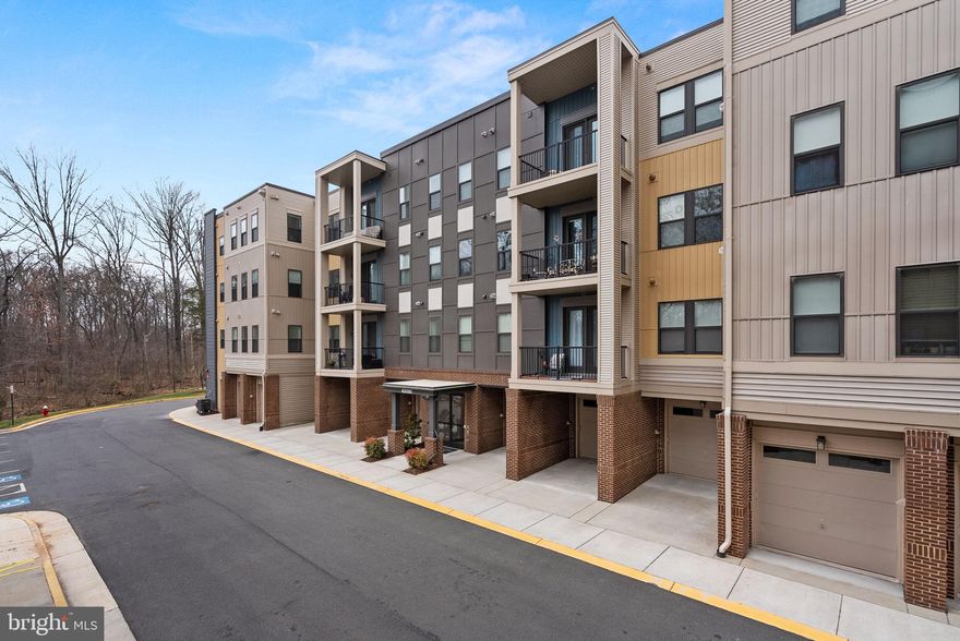 Offer Deadline: TODAY 3/25 at 1:00 pm. Enjoy privacy & convenience in Broadlands' 55+ Active Adult Community!  Discover this gorgeous open-concept condo on the TOP FLOOR of an elevator-equipped building, merely 4.5 years old and backing to trees. This like-new home boasts 3 bedrooms, a den, 2 full bathrooms, 1-car garage and driveway parking space! The beautiful gourmet kitchen features stainless steel appliances, granite countertops, stove w/double oven, upgraded soft-close cabinets, and a large breakfast bar. The primary and secondary bathrooms also have upgraded cabinets and granite counters!  Additionally, you'll appreciate the cozy electric fireplace, the lovely balcony, and the spacious laundry room. Other highlights include wide-plank hardwood floors and an abundance of natural light from beautiful windows equipped with silhouette and custom shades. The QUIET top-floor location is sure to impress. If you're working from home, the spacious den provides the perfect space for your telecommuting needs – complemented by excellent FIOS connectivity.  TV in living room conveys! The building offers a meeting/party room for resident use. Embrace an ACTIVE lifestyle with ease in BROADLANDS, thanks to amenities like pools, a fitness center, tot lots, trails, sport courts, outdoor concerts, social events, and more. Its fantastic location is near numerous walking trails and directly across from the Broadlands Marketplace/Southern Walk Plaza, which features a grocery store, drug store, restaurants, a tire shop, a nail & hair salon, etc. Plus, the Silver Line Metro is only 2 miles away. You're just minutes from INOVA Hospital and have easy access to Rt. 28, Rt. 7, the Dulles Toll Road/Greenway, and Dulles Airport. Make an appointment now!