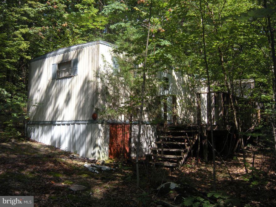 Unique opportunity here to purchase 2.9 acres of wooded land with a short walk to the  *Pauls Woods" community  access point into the Short Mountain Wildlife Management area.  Short Mountain consists of over 8,000 acres owned and maintained by the West Virginia Division of Natural Resources.  Hunt, camp, hike.  The North River (close by)  is stocked with trout seasonally.  Old mobile home on the property is not usable. Mobile homes are allowed. The HOA is not active.  Set up your own camper, invite your buddies, and hunt Short Mountain.