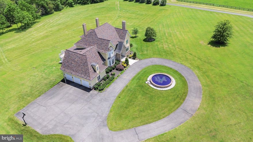 Welcome to your dream home: a breathtaking 6,526 sq ft custom-built estate nestled on 11.71 rolling acres of natural beauty and serene privacy. This one-of-a-kind property offers the perfect blend of modern luxury and rural charm, complete with a 1-acre pond, a spring house, and professionally landscaped grounds. A grand circular driveway welcomes you home, featuring a beautiful focal-point fountain that sets the tone for the elegance found throughout. 

Inside, the dramatic two-story foyer showcases a sweeping staircase and stunning Palladian windows that flood the home with natural light. Designed for both everyday living and impressive entertaining, the main level offers a formal dining room, a spacious office with French doors, and a two-story family room centered around one of three cozy fireplaces. The gourmet island kitchen is a chef’s dream, complete with a gas stove, pot filler, dining area, and its own fireplace, also huge pantry and warming drawer—perfect for intimate meals or large gatherings. Just off the kitchen is a convenient main-level laundry room and a stylish half bath. 

Also on the main level, the private primary suite is a true retreat, featuring a personal balcony with panoramic views, a cozy sitting room, an opulent spa bath, and a walk-in closet that is nothing short of extraordinary. There is also another impressive half bath for guests off of the family room.  

Upstairs, you'll find five spacious bedrooms, each with walk-in closets. Three of the bedrooms offer private ensuite baths, while the remaining two share a beautifully appointed Jack and Jill bath. One upstairs bedroom even features its own gas fireplace, adding a special touch of warmth and luxury. 

The fully finished walk-out lower level is an entertainer’s paradise, boasting an expansive open layout with high ceilings, a full-service wet bar with seating for six, a dishwasher, refrigerator, icemaker, and gas stove. There is a sitting area with built-ins for watching some TV, and special areas for gaming and exercise.  Also included is a “his and her” bathroom, an additional bedroom, and a state-of-the-art theater room with surround sound included to complete this incredible space. Step outside to the screened-in porch or enjoy the balcony that stretches across the back of the house, offering sweeping views of the property’s natural landscape and tranquil pond. There is plenty of space to add a pool, or other entertainment areas. 

Additional features include a new roof installed in 2022, geothermal heating and cooling for energy efficiency, and an attached three-car garage. This home offers modern amenities and timeless design, tucked away in a peaceful location that’s ideal for commuters. Whether you're looking to host elegant gatherings or simply escape the everyday hustle, this property delivers the space, comfort, and beauty to live your best life.