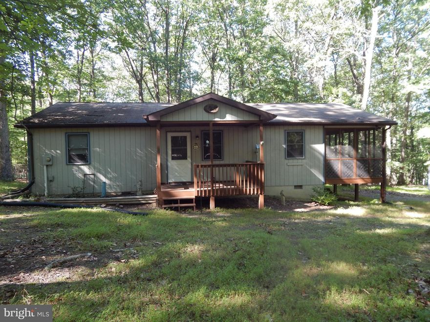 Cacapon River Access!!  Situated on 3.18  Acres in gated communty, this well maintained cabin is the perfect get away from the business of the city. One level living features a open Living Room/Dining/Kitchen with a pellet stove and vaulted ceiling.    Dining and Living room lead to a spacious screened deck as well as an open deck with ramp to fenced yard.   2 bedroom and 1 bath complete the floor plan.   Shed for extra storage.  Less than 2  miles from the community park, which features restroom facilities, BBQ pits, picnic tables, canoe/kayak rack, and access into the Cacapon River for fishing, swimming, or kayaking.  Seller has prepaid for driveway snow removal  for upcoming year.