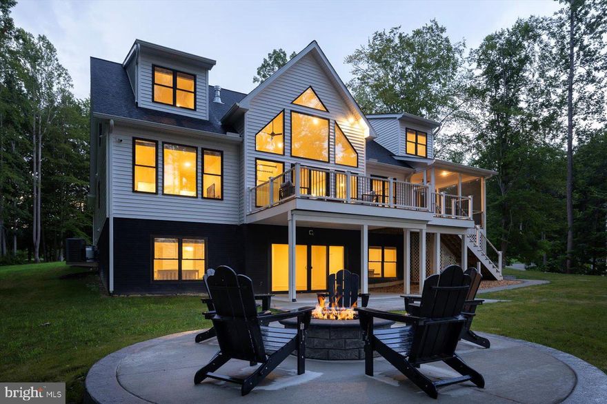 A luxurious lakefront retreat at Lake Anna, VA.  Built in 2024 and offered furnished, this stunning craftsman-style home is truly turnkey, has high speed fiber internet, and is ready for your immediate enjoyment.  Nestled in the sought-after Noah’s Landing subdivision on the private side of Lake Anna, this property offers 178 feet of pristine riprapped shoreline, a sandy beach, and a covered boathouse with composite decking, and a spacious sun deck that is partially covered.   The boathouse is already equipped with electricity and water!  Back at the house you'll enjoy breathtaking lake views in this 5-bedroom, 5.5-bath custom home, where each bedroom features its own private en suite.  With over 4,200 square feet of living space (plus an additional 981 square feet of unfinished basement space), there’s plenty of room for everyone to relax comfortably.  The main level showcases soaring vaulted ceilings, a gorgeous wall of windows overlooking the lake, and a floor-to-ceiling stone gas fireplace that anchors the open-concept living area.  The kitchen shines with sleek quartz countertops, a large center island with seating, stainless steel appliances, and a farmhouse sink, perfect for entertaining your family and friends.  Also on the main level are two bedroom suites, a private office, mudroom, laundry room, and a half bath.  Upstairs, you’ll find two additional bedroom suites and a cozy reading nook or game area. The walkout lower level offers a massive family and rec room, a fifth bedroom, full bath, and two large storage areas with potential for future finishing.  Outdoor living is just as impressive, with a screened-in lakeside porch, an expansive composite back deck, a concrete patio with fire pit, and professionally designed hardscaping throughout.  Lake-fed irrigation, a paved driveway, and  2-car garage.  Nestled on a 1 acre lot and on a quiet cul-de-sac.  This exceptional waterfront property offers luxury, privacy, and the perfect location.  Your Lake Anna dream home is ready to start making memories and let your stress drift away.