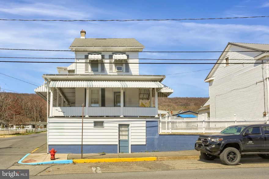Built in the Early 1900s, this home was originally a hotel. With some of the original features and footprints and over 1500 sq foot of above grade living space, this home allows good living space and more once the basement is updated. Carport with attached garage keeps your vehicles dry and protected in the elements. Fenced in corner lot with sidewalk to your back deck make it easy for transporting groceries. Step onto your enclosed porch with new sliding doors to allow cool breezes and mountain views as you drink your morning coffee. Large eat in kitchen with island is an entertainer's paradise. Two spacious rooms for living/ dining complete this space. Small toilet area on the first floor has extra storage space you will love to have. A new open stairway in the kitchen leads to upstairs that boasts a nicely redone bath and three bedrooms with an extra room that could be used for office, closet or storage. This room has access to an attic that could easily be converted to another bedroom or living space. The remaining three bedrooms are pass through rooms that could be separated with your vision. Basement space was once finished and used as a den space. Functional laundry/ half bath area completes the usable space. Workspace and utility room are housed in this area as well. Owner pride is evident in this home and the list of improvements verify this. Priced to sell, this is a great investment. Come take a look.