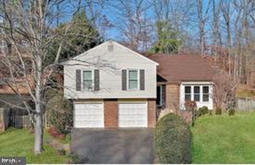 TRULY SPECIAL 4 BR, 3 BA Contemporary Split Level tucked into a quiet cul-de-sac in desirable Terra Grande community.   >> > DILIGENTLY MAINTAINED with  New Roof (Nov. 2025) + High Efficiency HVAC Heat Pump System (2023) + Preventive Outdoor Drainage System with Sump Pump (2020) + Crawlspace Sump Pump (2024)  >>> THOUGHTFULLY UPDATED:  Open Concept Floor Plan with Remodeled Kitchen, New High Efficiency Direct Vent Gas Fireplace, Dining/Sunroom Addition, New Paint, Refinished Hardwood Floors, New Carpet, Decorative Orleans-Style Wrought Iron Railings on Staircase & Balcony overlooking Living Room with dramatic 2-Story Vaulted Ceiling.  Upstairs, a Wide Open Common Area features a re-imagined Custom Kitchen with solid Maple Cabinets topped with Granite Counters, a 7-ft Breakfast Island with an inset sink and stylish pendant lights, a ducted range hood, new microwave (Dec. 2025) and range (Nov. 2025), a 2024 refrigerator, and a like-new dishwasher.  The focal point of the adjacent family room is the 2024 Natural Gas Fireplace with a Chic Custom-Designed Surround.  The dining/sunroom was added, complete with a Cathedral Ceiling, Skylights and Nature Views.  Exit to a private, wooded fenced-in backyard - a birder's paradise!  Admire seasonal blooms, delightful shrubs and ornamental trees displayed in terraced garden beds.  Host BBQs on your low maintenance composite deck.  A private hallway presents a huge primary suite with generous closet space.  The updated en suite BA has a large walk-in shower and a mirrored vanity nook for make up and hairstyling.  Down the hall, two sizable BRs share an updated Hall BA.  The fully finished ground floor offers a 4th BR (with window & closet) and a 3rd full BA.  If not needed as a BR, this large, versatile room is perfect for media/gaming, a gym, or home office.  The utilities & laundry are on this level, and a bonus room for storage, gym equipment or a home office as needed.  Exit to the spacious two-car garage.  Whether reporting to Fort Belvoir, the Pentagon, or somewhere in between, 95/395/495 and the Fairfax County Parkway will get you there!  With a Unique, Modern Floor Plan, Thoughtful Updates and a Peaceful Location within an Inviting Neighborhood, YOU WILL LOVE YOUR NEW HOME!