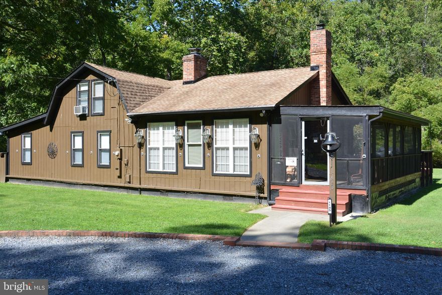This one checks all the boxes.  The 3 bed/2 bath cottage is in great condition.  The structures (house, garage, shed) are on 5 acres and included is the adjacent 4+ acre lot.  Both lots front on Dillons Run Trout Stream, with total frontage of 800+ ft.  Dillons Run is a state recognized trout stream, stocked by the state (when funds are available).  The creek is about 12' wide.  The extra lot is buildable., or use the level, large grassy area for recreation. The community offers a swimming lake with beach, playground, picnic pavilion, tennis court and a separate fishing lake (stocked).  The cottage has had many recent upgrades.  (The owner is a Contractor).  Much flooring has been installed throughout.  The family-room is massive, at 27 x 19 with a woodstove that offers warmth on the cold mountain days.  The adjacent living room has a woodburning fireplace that also has a woodstove installed.  (You'll see stacks of wood in the garage lean-to as well as the woodshed.  The stoves are well used and thoroughly enjoyed).  There is a sunroom off the kitchen, a screened side porch (27 x 10), 2 rear decks, 25 x 12 and 14 x 12.  Great views of the creek and a creek fed pond from porch and decks.  Above the sunroom is a deck off the upper main bedroom.  That bedroom is quite unique with all exposed pine, a full bath, and walkout to upper deck.  Check out all the photos.  They really don't do the property justice as you have to visit to really take it in.  There is a 3 bay oversized garage (36 x 28) with a 36 x 11 "lean-to" off the back.  Jump in your ATV for a trip down to the fishing lake, or up the road to the swimming lake and other amenities.  Half the land is wooded, up the hillside, offering a place to shoot, hunt, hike, chop trees.