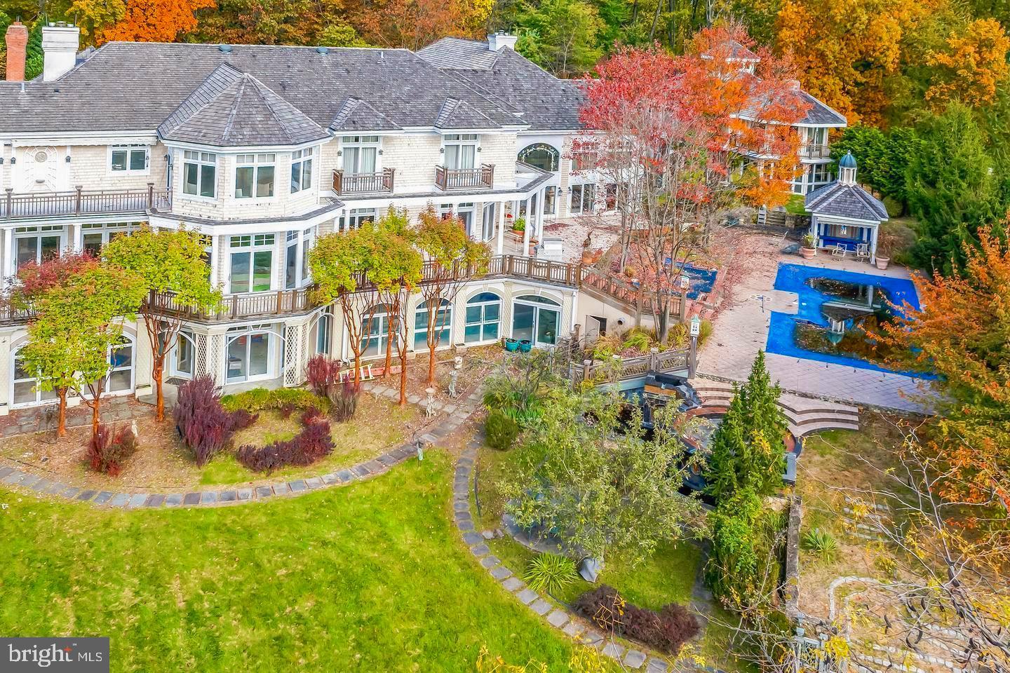 MOVE IN READY REO FOR SALE!!! SELLER WILL ENTERTAIN ALL SERIOUS OFFERS FOR THIS 14,000 SF MANSION SITTING ON 4.9 ACRES!!! Discover the epitome of luxury living in this magnificent Malvern mansion with meticulous attention to detail which exudes unique architectural design. This amazing property is perfectly positioned as the last house at the top of a tranquil cul-de-sac. Spanning an impressive 14,000 sq ft and set on nearly 5 acres of pristine land, this home offers unparalleled privacy, breathtaking views, and an abundance of natural light thanks to patio doors in every room. Property has 6 bedrooms each with its own private deck/balcony, 7 full baths and 2 half baths. Two stunning cherrywood grand staircases with bridges creating a dramatic entrance. Beautiful wood and tile floors throughout. 4-car garage plus a separate guest parking area. Wrap-around driveway with a beautiful water fountain. A full library perfect for book lovers. Formal dining room, formal living room w/fireplace. Kitchen great for culinary enthusiast's, enjoy the 6-burner range and 2 sub-zero refrigerators. Breakfast room with awesome view to patio and inground pool. The family room is a work of art with a fireplace and a stunning mural on the 24–26-foot ceilings. The three fireplaces made from stone, marble, or tile add a touch of elegance and warmth to the home. Luxurious primary suite with a large deck is a wonderful retreat for relaxation and taking in the view of the surroundings. Large separate shower, jetted tub, and his & her closets. 5 additional bedrooms, all but one has an en-suite bathroom. Laundry room conveniently located on the second floor, Lower-Level Extravaganza features a separate theater room, bar, gym, dance hall, and an elevator for those times when you want to get to the next floor(s) in a hurry, carrying heavy items or you're just feeling lazy or too tired to take the stairs. Lap pool & hot tub. Add'l buildings consist of a separate pool and carriage house, Carriage House has a workshop and bathroom on the first floor and a fully equipped 1 bedroom apartment on the second floor with add'l bath. The serenity and breathtaking views of 52 Mountain Laurel Lane create an idyllic escape from the hustle and bustle of the outside world. The feeling of complete solitude allows you to recharge and find peace within your own private oasis. Although civilization is just a stone’s throw away., within 30 seconds, you can access all the conveniences whether it’s hopping on the nearby Paoli train, grabbing groceries, or enjoying a meal at a local restaurant. It’s the perfect balance of seclusion and accessibility. This property truly offers the best of both worlds, a sanctuary where you can unwind and recharge. In addition, this mansion has all of the entertainment you could imagine such as a movie theater, gym, inground pool, indoor lap pool, hot tub, bar and dance hall, etc. What more could you possibly need, nothing this is it! Living at 52 Mountain Laurel Lane is like being on a perpetual vacation. Close to the turnpike exchange off of Rt 29 and Paoli train station, shopping, schools, restaurants and dining, golf and country clubs. Schedule your tour today, you won't regret it!