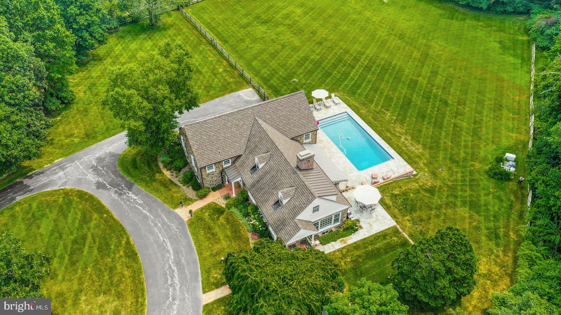 Located on sought after Greenbriar Lane, a quiet private cul de sac in Willistown Township. This house will not disappoint!! Drive in the majestic circular drive to this charming stone home where the covered portico welcomes you. If this home wasn't originally built by Brognard Oakie, it certainly was inspired by his designs. Walk into the brick foyer and step down into the huge living room with wood burning fireplace and beamed soaring ceilings. The French door opens to the beautiful flagstone, awning covered patio that leads to the beautiful pool, decking and grounds beyond. The wonderful flow of this home continues to the light filled dining room whose Dutch door opens to its own patio and views beyond. Circle back around to the incredibly efficient kitchen which runs along the front of the home. The main bedroom suite is its own sanctuary with its own private office or den, large walk in closet and gorgeous bath. 2 additional bedrooms, each with breath taking views and hall bath complete this floor. The next level houses a large 4th bedroom and luxurious bath, could be an additional main bedroom or a bonus/ playroom or guest suite. The lower level features a family room, full bath a good size laundry room plus access to the attached 2 car garage and basement with plenty of storage. This magnificent property has been professionally landscaped and maintained, 4 Greenbriar lane is extremely private yet convenient to all the Main Line has to offer and provides easy access to the Paoli Amtrak and Septa station, Radnor Hunt, Waynesborough Country Club, premier shopping and schools..
A One Year HSA Home Warranty will be given to the Buyer at Closing....