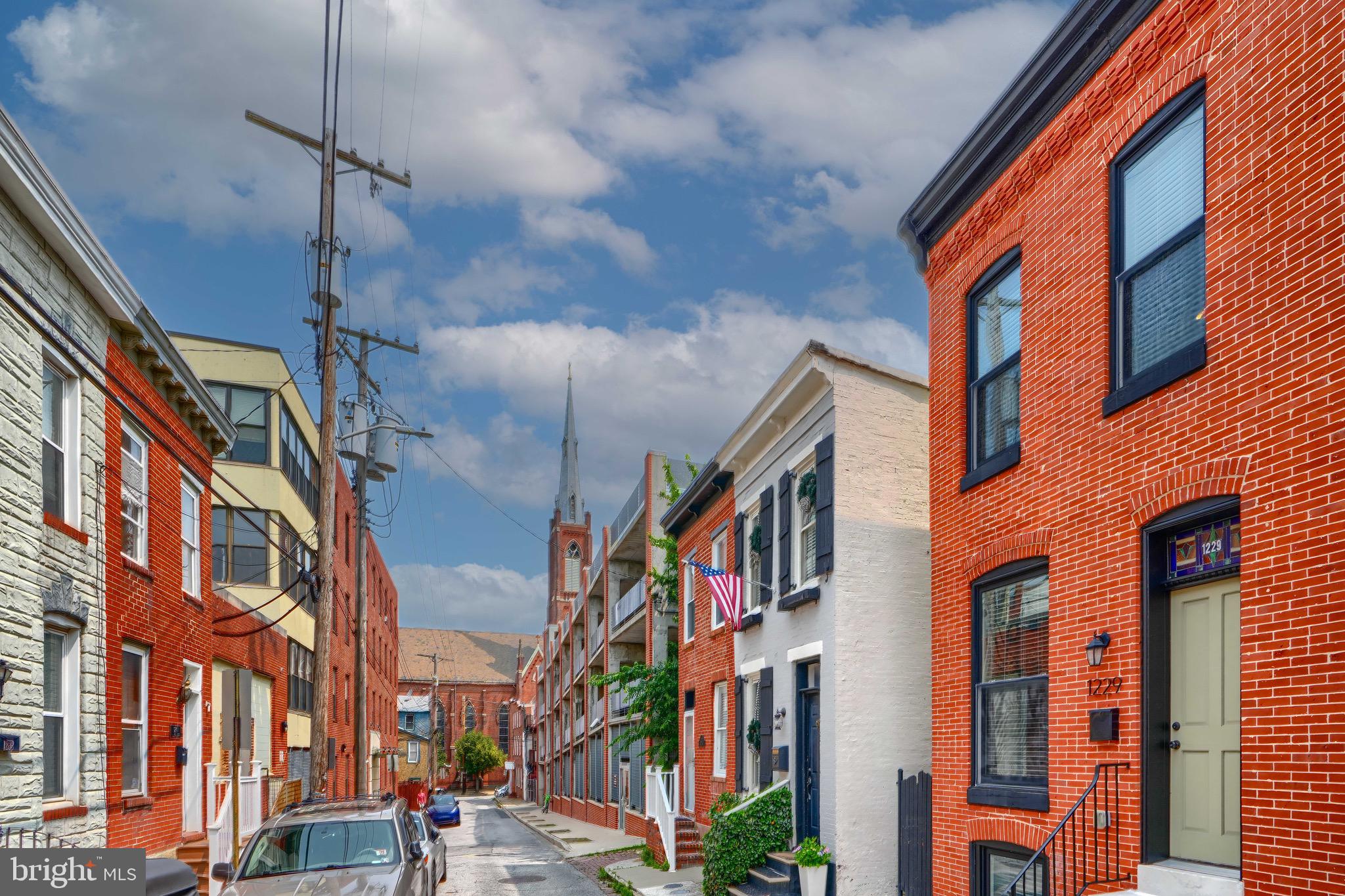 CHAP Historic Federal Hill Townhouse | 3BR | 3.5BA | Renovated | Roof Deck | Parking
Located on a quiet, charming block in Historic Federal Hill, 1229 Wall Street is a fully renovated 3-level rowhome offering the perfect blend of classic Baltimore character and modern convenience. With 3 bedrooms and 3.5 baths, this home includes a fully finished lower level suite—ideal as a third bedroom, guest space, or home office.
The main level features an open floor plan with hardwood floors, exposed brick, and a chef’s kitchen outfitted with stainless steel appliances, quartz countertops, and custom cabinetry. Upstairs, two spacious bedrooms each have en-suite baths and ample closet space.
Step outside to a private rooftop deck with panoramic city views—perfect for relaxing or entertaining. The home also includes a rare oversized parking pad in the rear, central air, and updated systems throughout.
Just steps to Federal Hill Park, Cross Street Market, Inner Harbor, and the city’s best restaurants and shops—this move-in-ready home offers the best of city living. CHAP tax credit & Ground rent to be verified by buyer.