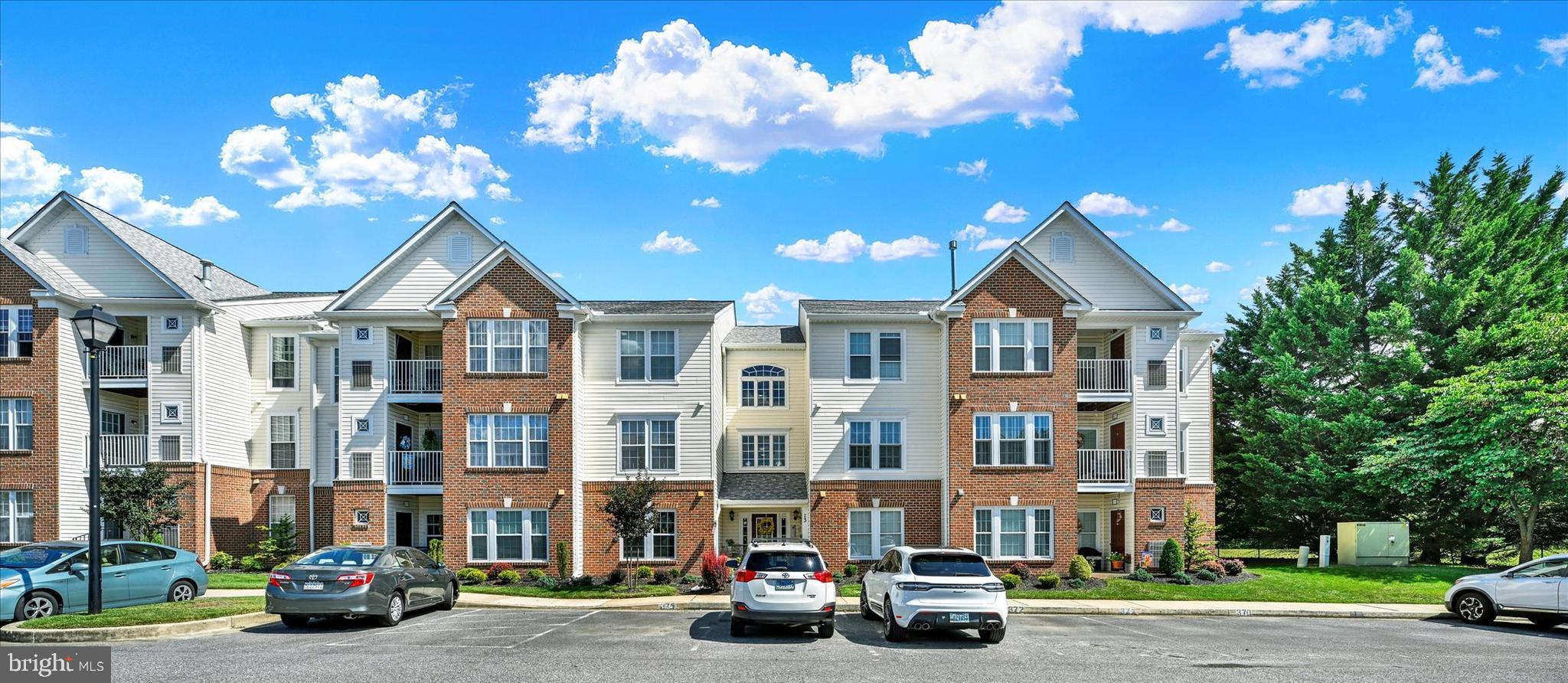 Discover the charm of this inviting 2-bedroom, 2-bathroom garden condo nestled in the serene Perry Hall Farms community. With 1,214 sq. ft. of thoughtfully designed living space, this home features an open floor plan that seamlessly connects the dining area and living spaces, perfect for entertaining or cozy evenings at home. Elegant crown moldings, cathedral ceilings and warm hardwood floors enhance the inviting atmosphere, while recessed lighting adds a touch of modern sophistication. The well-appointed kitchen boasts essential appliances, including a built-in microwave, dishwasher, and refrigerator, making meal prep a breeze. Enjoy the convenience of in-unit laundry with both a washer and dryer, ensuring your daily routines are effortless. Step outside to your private balcony, where you can unwind and take in the tranquil views of the surrounding trees and open common areas. The beautifully landscaped grounds invite leisurely strolls along the nearby jog/walk path, while the picnic area offers a perfect spot for gatherings. This condo also includes one assigned parking space and additional guest parking. With easy access to common areas and an elevator for convenience, this home is designed for comfort and ease. Experience the perfect blend of modern living and natural beauty in this 3rd floor, rear facing condo overlooking common grounds. Reserved parking space #375 in front of the building