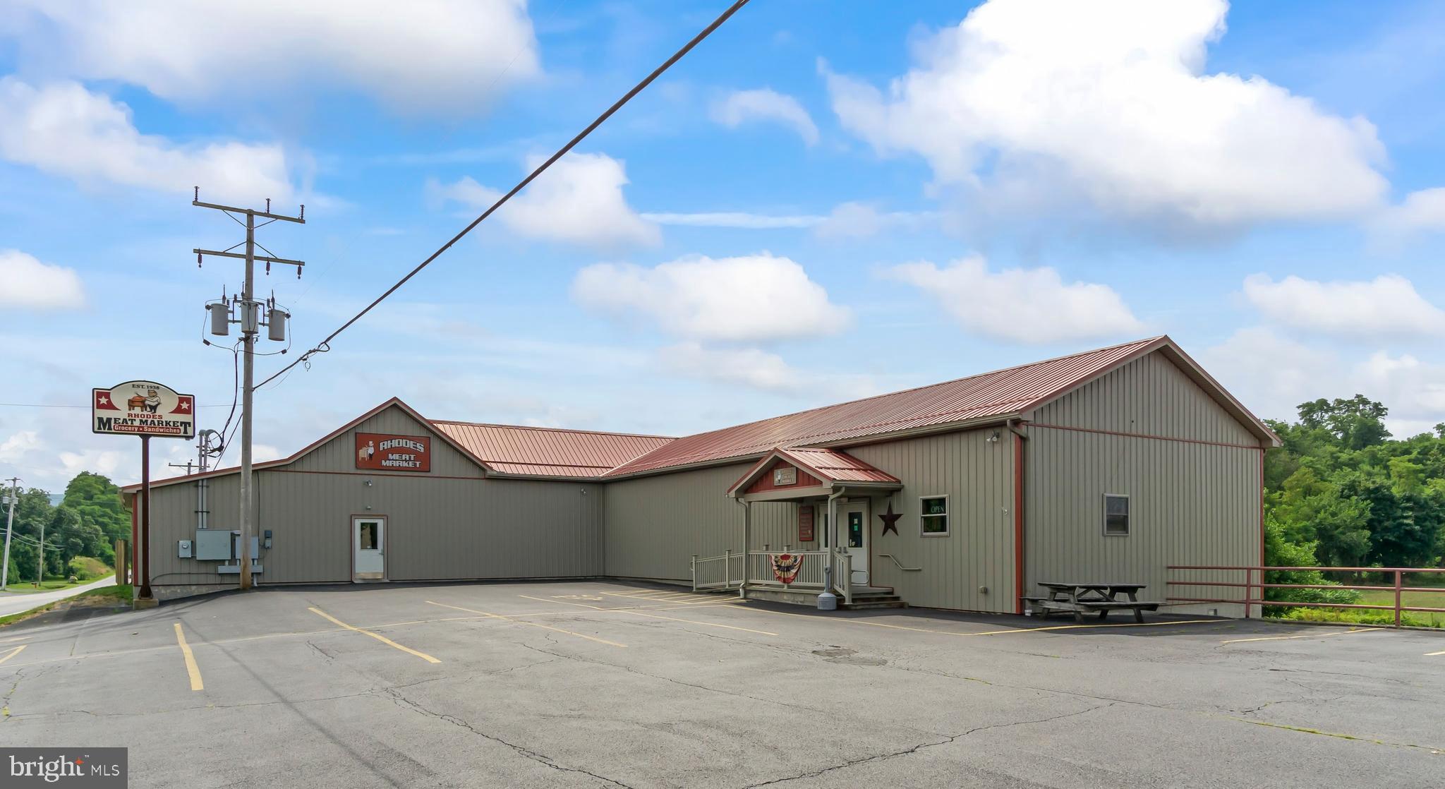 Strategically located on Route 164, enroute to Raystown Lake, Rhodes Meat Market, a 4-generation, family-owned business, offers established cliental with potential for growth. Situated on approximately 7 acres, the setting may allow for additional development. Current setup includes 2 processing rooms, 3 walk-in coolers, a walk-in freezer, certified scales, and exterior corral pens. A freight elevator and attractive sales floor makes the company efficient and appealing. Meat market equipment will convey allowing an immediate business opportunity! The existing inspector’s office allows for wholesale opportunities as well. Lower level includes a freshly painted owner’s office, spacious break room, and commercial bathrooms.