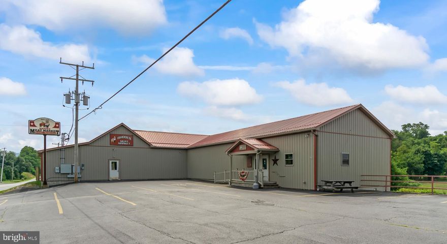 Strategically located on Route 164, enroute to Raystown Lake, Rhodes Meat Market, a 4-generation, family-owned business, offers established cliental with potential for growth.  Situated on approximately 7 acres, the setting may allow for additional development.  Current setup includes 2 processing rooms, 3 walk-in coolers, a walk-in freezer, certified scales, and exterior corral pens.  A freight elevator and attractive sales floor makes the company efficient and appealing.  Meat market equipment will convey allowing an immediate business opportunity!  The existing inspector’s office allows for wholesale opportunities as well.  Lower level includes a freshly painted owner’s office, spacious break room, and commercial bathrooms.