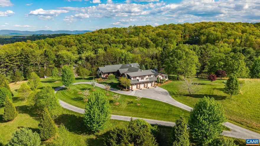 This is an incredible home on acreage in Staunton, Virginia. A private driveway leads you up to the home that boasts breathtaking panoramic mountain and valley views. Thoughtful landscaping surrounds the home. The large, 7,000 square foot custom home has stone accents and beautiful wooden beams. Once inside, you will immediately notice the incredible attention to detail, with custom wood flooring and finishes throughout. The kitchen has a large island with a Wolf range and double ovens. The primary bedroom has access to the patio and has a gas fireplace. There are 2, separate primary bathrooms with walk in showers and very large separate walk in closets. One room has a custom built loft area with a ladder and intricate woodwork. The basement is a fully finished, walk out basement with a wet bar and billiards area. There is a spacious, 3 car garage including a finished apartment area above. There is also an additional garage attached to the basement that is perfect for a workshop area and equipment. The property is served by city water and sewer! Fiber internet is available. It is extremely hard to find this size and quality of home accompanied by views and acreage with city utilities. Additional acreage is available if desired.,Granite Counter,Oak Cabinets,Wood Cabinets,Fireplace in Living Room,Fireplace in Master Bedroom