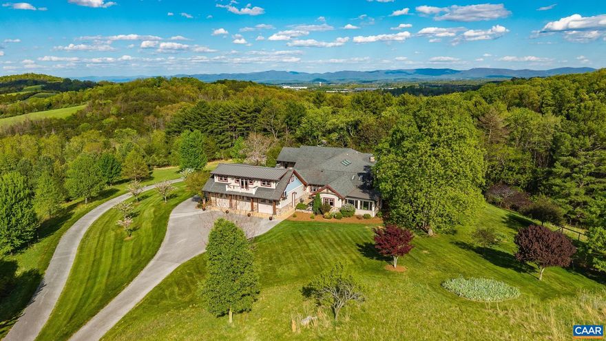 This is an incredible home on acreage in Staunton, Virginia. A private driveway leads you up to the home that boasts breathtaking panoramic mountain and valley views. Thoughtful landscaping surrounds the home. The large, 7,000 square foot custom home has stone accents and beautiful wooden beams. Once inside, you will immediately notice the incredible attention to detail, with custom wood flooring and finishes throughout. The kitchen has a large island with a Wolf range and double ovens. The primary bedroom has access to the patio and has a gas fireplace. There are 2, separate primary bathrooms with walk in showers and very large separate walk in closets. One room has a custom built loft area with a ladder and intricate woodwork. The basement is a fully finished, walk out basement with a wet bar and billiards area. There is a spacious, 3 car garage including a finished apartment area above. There is also an additional garage attached to the basement that is perfect for a workshop area and equipment. The property is served by city water and sewer! Fiber internet is available. It is extremely hard to find this size and quality of home accompanied by views and acreage with city utilities. Additional acreage is available if desired.,Granite Counter,Oak Cabinets,Wood Cabinets,Fireplace in Living Room,Fireplace in Master Bedroom