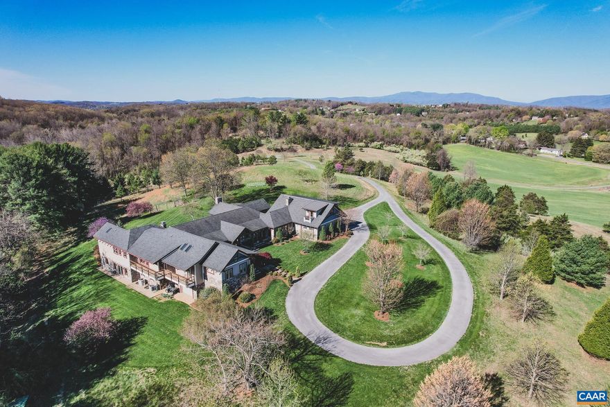 This is an incredible home on acreage in Staunton, Virginia. A private driveway leads you up to the home that boasts breathtaking panoramic mountain and valley views. Thoughtful landscaping surrounds the home. The large, 7,000 square foot custom home has stone accents and beautiful wooden beams. Once inside, you will immediately notice the incredible attention to detail, with custom wood flooring and finishes throughout. The kitchen has a large island with a Wolf range and double ovens. The primary bedroom has access to the patio and has a gas fireplace. There are 2, separate primary bathrooms with walk in showers and very large separate walk in closets. One room has a custom built loft area with a ladder and intricate woodwork. The basement is a fully finished, walk out basement with a wet bar and billiards area. There is a spacious, 3 car garage including a finished apartment area above. There is also an additional garage attached to the basement that is perfect for a workshop area and equipment. The property is served by city water and septic! Fiber internet is available. It is extremely hard to find this size and quality of home accompanied by views and acreage with city utilities. Additional acreage is available if desired.,Granite Counter,Oak Cabinets,Wood Cabinets,Fireplace in Living Room,Fireplace in Master Bedroom