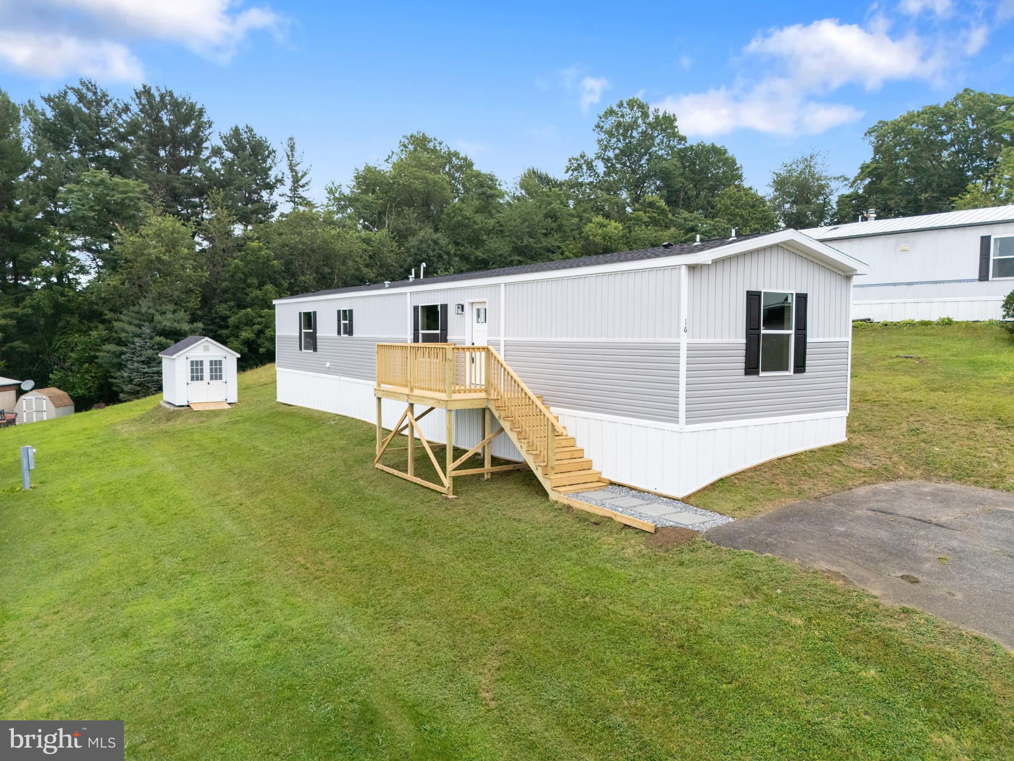 Welcome to your brand new mobile home in the Margaretta MHP Community! Nestled in a beautiful and secluded location within the Eastern York School District, this home offers both privacy and convenience. As you step through the front door, you'll be greeted by an open layout that creates a spacious and inviting atmosphere. The kitchen boasts tons of cabinet space, tastefully designed to accommodate all your cooking needs. The living room features an accent wall, adding a touch of charm to the space. With 3 bedrooms and 2 bathrooms, there's plenty of room to relax and unwind. Plus, washer dryer hookups make laundry day a breeze. This home is E Built, which means it is 30-50% more energy efficient then other manufactured homes. Insulation, Energy Star appliances, specialized water heater and windows all contribute to its energy efficiency. This home is also Zero Energy Ready which means it can be connected to solar or wind easily. Outside, you'll find a brand new 8x10' Stoltzfus A Frame Shed with Cupola included with the home, providing ample space for all your storage needs. One year limited home warranty included with the sale. Don't miss out on the opportunity to make this beautiful mobile home yours. Call today to schedule a tour! *Central AC can be added for an additional $5000*