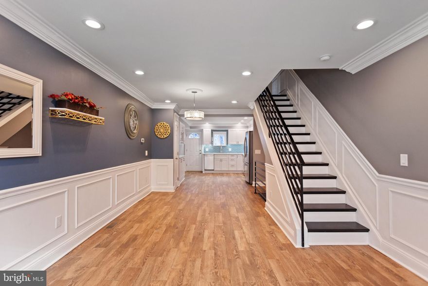 A stunning, new listing in Pennsport. A 2 story, 3 Bedroom, Designer- like home rehabbed a few years ago. First floor FIRST IMPRESSIONS - WOW! A beautiful, open floor plan with a huge bay window allowing great southern exposure. Hardwood look tiled floors, shadowbox, & crown molding throughout. All LED recessed lighting. A tastefully done eat-in kitchen with quartz counter tops, all self closed drawers, glass back splash, under counter lighting, stainless steel appliances, plus a separate dry bar with cabinets & quartz counter tops + a door to the yard. A wooden staircase with a metal railing leads you to the 2nd floor spacious hallway with lots of detailed woodwork. A front bedroom with great light and deep closet- Middle bedroom/office-  Full tile bath with linen closet- Good sized back bedroom with closet. Basement with nice ceiling height, mechanicals- washer, dryer, & storage. This property also has 200 AMP service & a new roof (2018). A great house on a nice street with free parking a half a block away. Easy to show!!