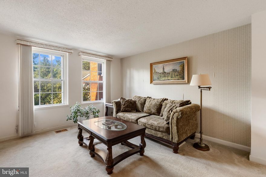 RARE opportunity to create your dream home in Fairlington with this 2-bedroom, 2-bathroom Clarendon II model townhome! Bring your vision & creativity to this spacious home nestled on a picturesque Fairlington courtyard. This as-is property is full of possibility! The main level features a welcoming entry with a coat closet, a bright living room, & a dining area with chandelier. There are hardwood floors hiding under the current carpet on this level, just waiting to be uncovered and enjoyed! The kitchen offers hardwood cabinets, recessed lighting, terra-cotta inspired tile flooring, & recessed lighting – an excellent foundation for a modern upgrade. A French door opens to a HUGE private balcony overlooking lush community greenspace, offering a peaceful outdoor retreat. 

Upstairs, you’ll be greeted by well-maintained hardwood floors, a hallway ceiling fan with overhead light, and two bedrooms! The spacious primary bedroom features a walk-in closet with built-ins and the 2nd bedroom includes two windows and a good-sized closet. A full bathroom with tile flooring, vanity, & tiled shower complete this level. The lower level includes a generously sized recreation room with plush carpeting and a large window, a bonus room that works well as a guest space or home office, and a full bathroom with corner shower, vanity, & laundry nook with a full-sized washer & dryer + large window.

With its prime courtyard location, ample living space, and endless renovation potential, this property is a true Fairlington gem. Whether you’re looking to invest or create your forever home, don’t miss this rare chance to make it your own! Home includes 2 reserved/unassigned parking spaces. Fairlington Villages residents enjoy six pools, lighted tennis courts, tot lots/playgrounds, walking paths, and MORE! Ideally located near I-395 and the shops & restaurants at The Village at Shirlington, West Alex, Baileys Crossroads, Del Ray, & Old Town!