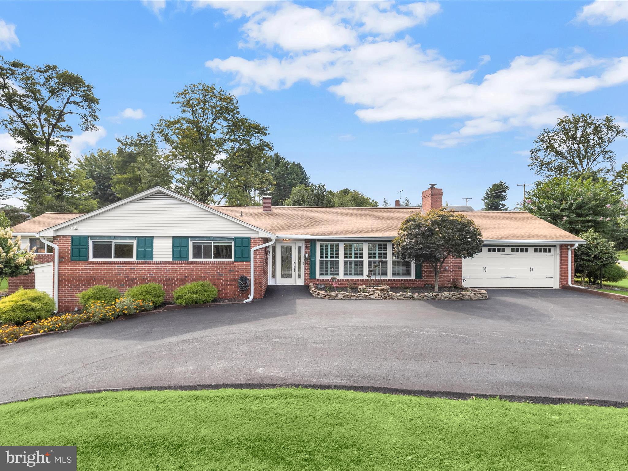 Introducing this three bedroom, two and a half bathroom home set on a 0.47-acre corner lot in the coveted Stevenson community. Graced by beautiful landscaping, this home offers a peaceful setting while still being minutes from shopping, dining, and major commuter routes. Generous side and backyards provide plenty of outdoor space for gardening, entertaining, or play, giving the home a sense of openness and versatility. Step inside to a welcoming foyer that leads into the spacious living room, where a cathedral ceiling, custom plantation shutters, hardwood floors, and a cozy gas fireplace create a warm and inviting atmosphere. The kitchen is appointed with stainless steel appliances, gas cooking, granite counters, and a decorative tile backsplash, blending both function and style. Just steps away, the dining room is enhanced with elegant crown molding and opens through a glass door to the deck and backyard, creating an easy connection for indoor and outdoor living. The primary bedroom suite has been expanded to create a spacious retreat. The addition features a sitting room, while the bedroom boasts a soaring cathedral ceiling, two closets, built-ins, and a dedicated mini-split system for comfort throughout the year. Completing the suite is a luxurious bathroom featuring a walk-in steam shower with bench seating and dual shower heads. Rounding out the main level are two additional bedrooms with a connecting French door and a second full bathroom with a tub shower. Downstairs, the lower level extends the home’s living space with a versatile recreation room and half bathroom, perfect for hobbies, gatherings, or casual lounging. A spacious laundry room with walk-out access to the yard, along with a utility room and separate storage room, adds convenience. Outdoor living is equally enjoyable with a private fenced area that includes a deck and a tranquil pond that enhances the setting. Additional open yard space offers room to spread out, and a storage shed is ideal for tools and outdoor essentials. A circular driveway and two-car garage provide plenty of parking.