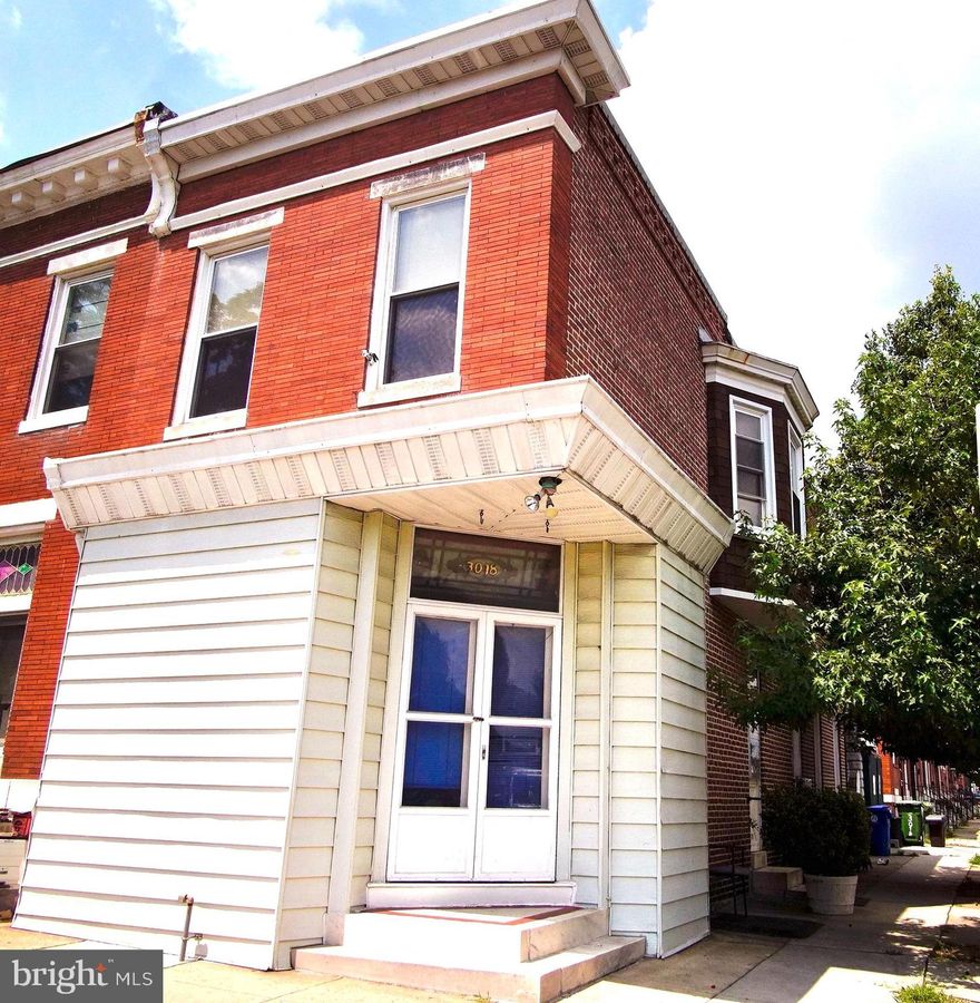 Historic, affordable end of group rowhome with 12+ foot ceilings and beautiful original details, including stained glass transoms, wood floors, and mostly unpainted wood trim and moldings. The home also has a courtyard and a detached garage. The main level has large rooms and opens to a storefront office space. Large eat-in kitchen with vintage gas range. The upper level has a skylight, 3 spacious bedrooms, and one full bath. The front bedroom has a fireplace. The middle bedroom has a lovely bay window and the rear bedroom  has a balcony off of the bedroom. The home has been well maintained. The garage is easy to access as an end of group. The basement has good ceiling height, a functioning toilet and washer and dryer-- the space is presently unfinished. This is an estate sale and the home is sold "as is".