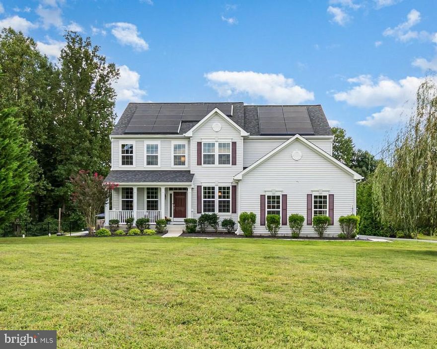 Step into your own private retreat with this stunning 5-bedroom, 3.5-bath Colonial with Craftsman influences, where timeless elegance meets modern comfort in a serene setting. The highlight of this home is a Solar System - paid in full and yours to keep! Paired with three Tesla Powerwalls in the basement storage room, allowing the property to operate fully off-grid if desired! The main floor, finished with rich hardwood throughout, welcomes you with a sun-filled living room accented with crown molding, followed by a formal dining room perfect for hosting memorable gatherings. The inviting family room features a stylish accent fireplace wall with a gas fireplace, creating a warm and sophisticated centerpiece. The heart of the home is the chef-inspired kitchen, showcasing striking two-tone cabinetry—crisp white with a deep brown island—highlighted by pendant lighting, granite counters, double ovens, a cooktop, and a double sink. Just beyond, a bright sunroom opens directly to the expansive composite deck, creating a seamless indoor-outdoor flow. A private office with elegant glass French doors provides the ideal workspace, while a conveniently located powder room completes the main level. Upstairs, the luxurious primary suite serves as a true sanctuary, featuring its own sitting lounge, tray ceiling, an oversized walk-in closet, and a spacious bathroom designed for relaxation. Three additional bedrooms offer generous comfort and are complemented by a well-appointed hall bath. The lower level offers flexible living with an open layout ideal for a home gym, media room, or a fifth bedroom, complete with a full bath and ample storage. Step outside to your private oasis: a beautifully landscaped yard anchored by a heated saltwater pool, designed for low maintenance and endless enjoyment. The large composite deck provides plenty of room for entertaining and includes practical storage beneath, fully enclosed with a lifting door. The garage includes a Tesla charger with compatible adapters for convenient EV charging, and the solar panels will be paid off at settlement—delivering exceptional value, independence, and sustainability. This property combines privacy, luxury, and exceptional craftsmanship in a coveted cul-de-sac location - truly a one-of-a-kind opportunity.