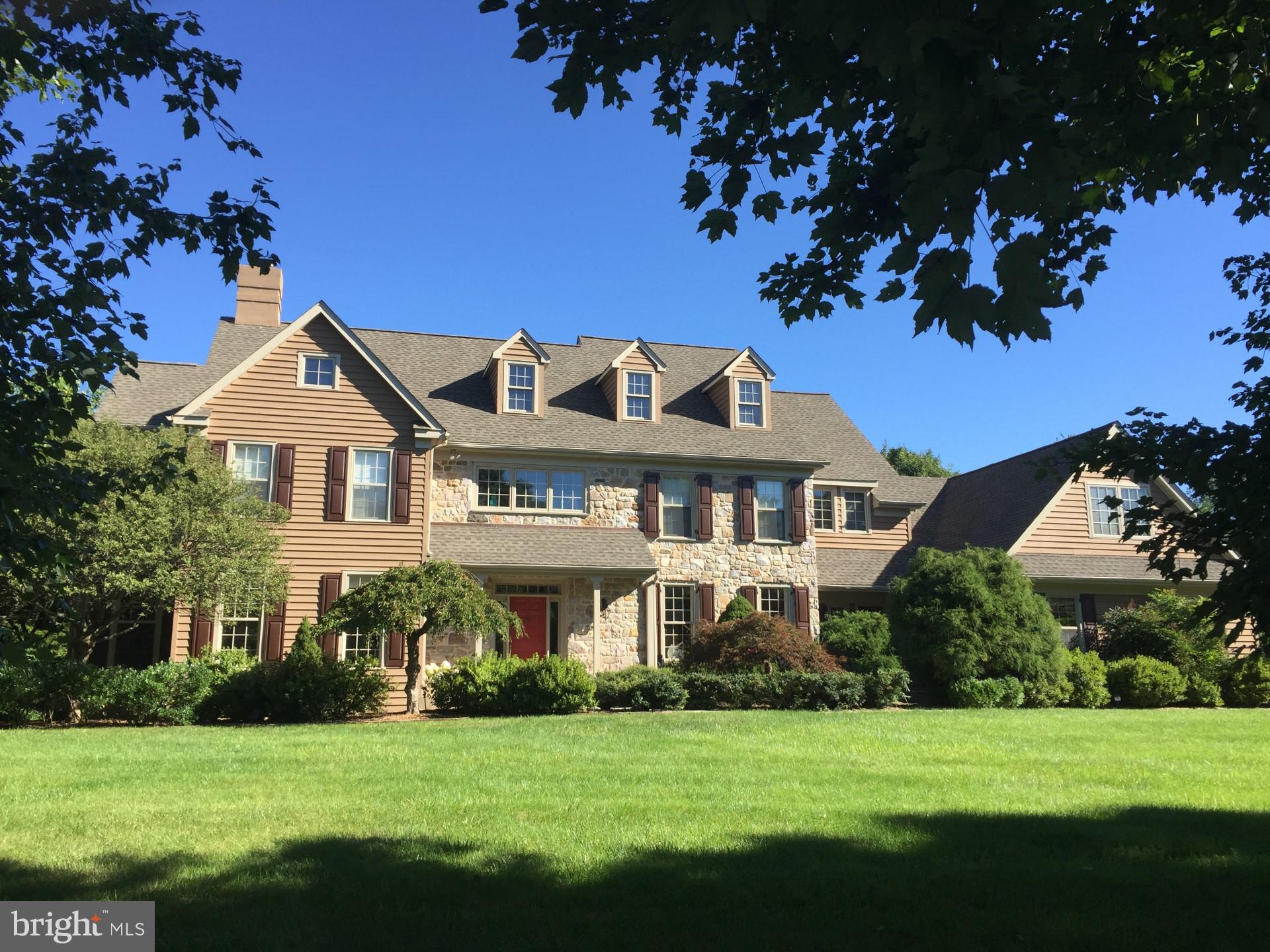 Down a quiet street in prestigious Lower Gwynedd, sits a beautiful custom-built Guidi Brothers home. Welcome to 955 Gladestry Lane, designed by award winning architect Ann Capron. This home, with over 4800 finished square feet, is one of sixteen in Lower Gwynedd’s Meadowview Farm subdivision. This 5 bedroom 4 ½ bath home sits on 1.1 acres in a quiet cul-de sac setting which is ideal for children to play in away from traffic, while at the same time convenient to the shops at English and Springhouse Villages! With curb appeal galore, a well-manicured winding walk-way leads you to the front door. Enter into the 2-story sunlit foyer where gleaming hardwood floors throughout the first floor greet you. A step down to the left of the foyer and you walk thru the living room with an abundance of windows and a wood burning fireplace settled underneath an elegant mantel of marble and millwork molding. Thru charming French doors off of the living room, you will find a convenient office/study with plenty of natural light from the oversized windows and wall mounted sound system built throughout the house. To the right of the foyer, is the formal dining room featuring chair rail with custom paint/wallpaper and 2 large windows, letting in even more natural light. Straight ahead, walk past the convenient half bath and hall closet and into the open eat in kitchen which features a large granite island, wet bar, and an abundance of cabinetry, as well as top of the line appliances including a Jenn-Air electric range with four Ceran round burners and two square grills and a Jenn-Air microwave and baking oven. The kitchen’s walls are lined with French White glazed wood cabinetry with detailed craftsmanship by Challew Kitchens. Sliders off of the breakfast area in the kitchen give lovely views of the patio with its decorative brick perimeter and the private back yard. The kitchen opens up to the cozy yet spacious family room with a floor to ceiling stone hearth and wood burning fireplace that would make any cold winter night feel cozy. A wall of sliding doors with additional access to the patio and back yard, make entertaining here a breeze. A large mud/ laundry room (complete with laundry chute!) off of the kitchen is equipped with two storage closets, a full bathroom and access to the outside as well as to the three-car garage. On the second floor you will find the cheerful owners’ suite, with a sitting area next to a bright bay window. A large walk-in closet gives way to the ensuite complete with double vanity, stall shower and soaking tub. Down a long hall, quite separate from the master bedroom, there is a second bedroom with ensuite as well as two additional bedrooms with a shared hall bath. A bonus room over the garage is at the end of this hall and offers a ton of possible uses. This large room could be used as a 5th bedroom, work out area or entertaining /hang out room for the kids. The enormous unfinished walk out basement is fantastic for storage and finishing this space off would allow for even more spaces to entertain! This home in this location has so much to offer! Located in the highly acclaimed Wissahickon School District, it is convenient to shopping at Whole Foods Market, Trader Joe's and Costco; Easy suburban train transportation to Philadelphia with Penllyn Station nearby; Quick access to Rt. 309 and PA turnpike and close proximity to prestigious private school options! This beautiful property in this perfect location is true gem!