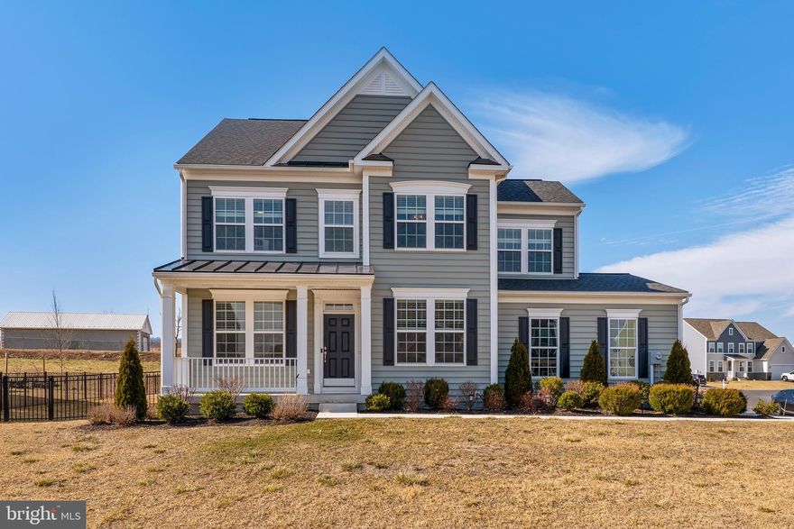 Nestled in the desirable Springdale Farms community of Gerrardstown, this stunning Newbury II colonial offers a perfect blend of style and functionality. Featuring a morning room addition and an extended family room, the open floor plan is ideal for modern living. The gourmet kitchen boasts 42-inch cabinetry, quartz countertops, stainless steel appliances, and a spacious island, perfect for cooking and entertaining. The inviting family room flows seamlessly from the kitchen, creating a warm and welcoming space.

Upstairs, the generous primary suite includes a luxurious en-suite bath and abundant closet space. The home also features a walk-up basement with rough-in plumbing, providing potential for future expansion.

Step outside to enjoy the beautifully landscaped, fully fenced backyard, complete with a patio, offering the perfect setting for outdoor gatherings. A side-load garage adds curb appeal and convenience. Don’t miss the opportunity to make this exceptional home yours!