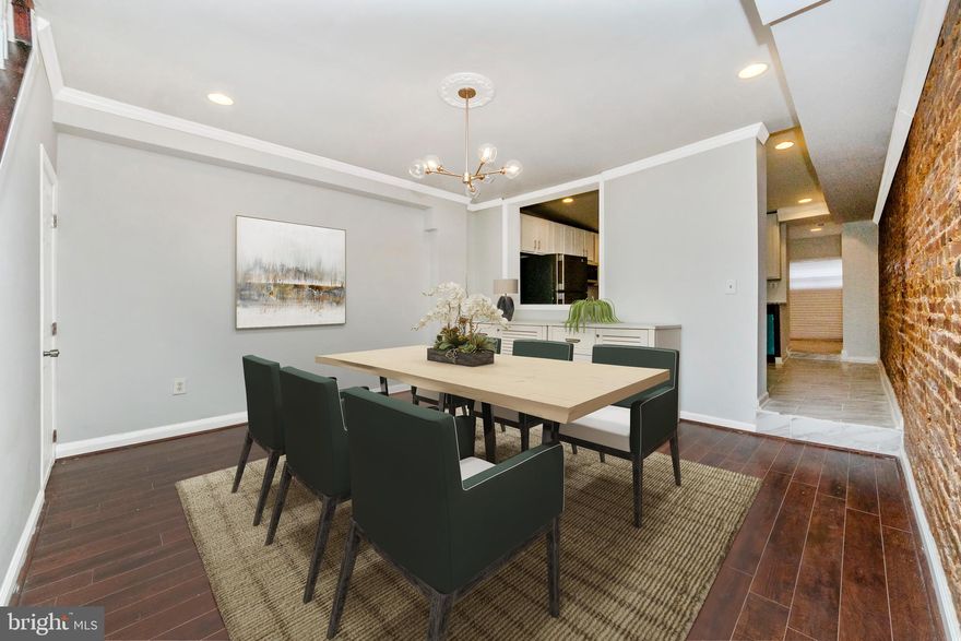Take advantage of $0 down payment home loan options and make homeownership more accessible than ever! Welcome to this newly renovated rowhome near Union Square, blending modern updates with classic Baltimore charm. As you step inside, you're greeted by hardwood floors throughout and a spacious living room featuring a brick accent wall and a cozy fireplace, adding warmth and character. The formal dining room is perfect for entertaining, accented by crown molding for a refined touch. The kitchen offers ample cabinet and prep space, two-toned cabinetry for added style, granite countertops, and stainless steel appliances. An open pass-through to the dining room enhances convenience. Behind the kitchen, you'll find a main-level laundry area and a full bathroom with a tiled stall shower. Upstairs, the primary suite is filled with natural light and features an ensuite bathroom with a custom tile tub/shower combo. Another spacious bedroom completes this level. The third floor offers two additional bedrooms and a full bathroom with a tub/shower combo, making this home ideal for larger households or guests. The lower level is unfinished, providing plenty of storage space. Outside, the fully fenced yard is perfect for hosting summer BBQs and entertaining guests. Conveniently located near Route 1, Route 40, I-95, and Downtown Baltimore, this home offers easy access to shopping, dining, and city amenities. Schedule your showing today!
