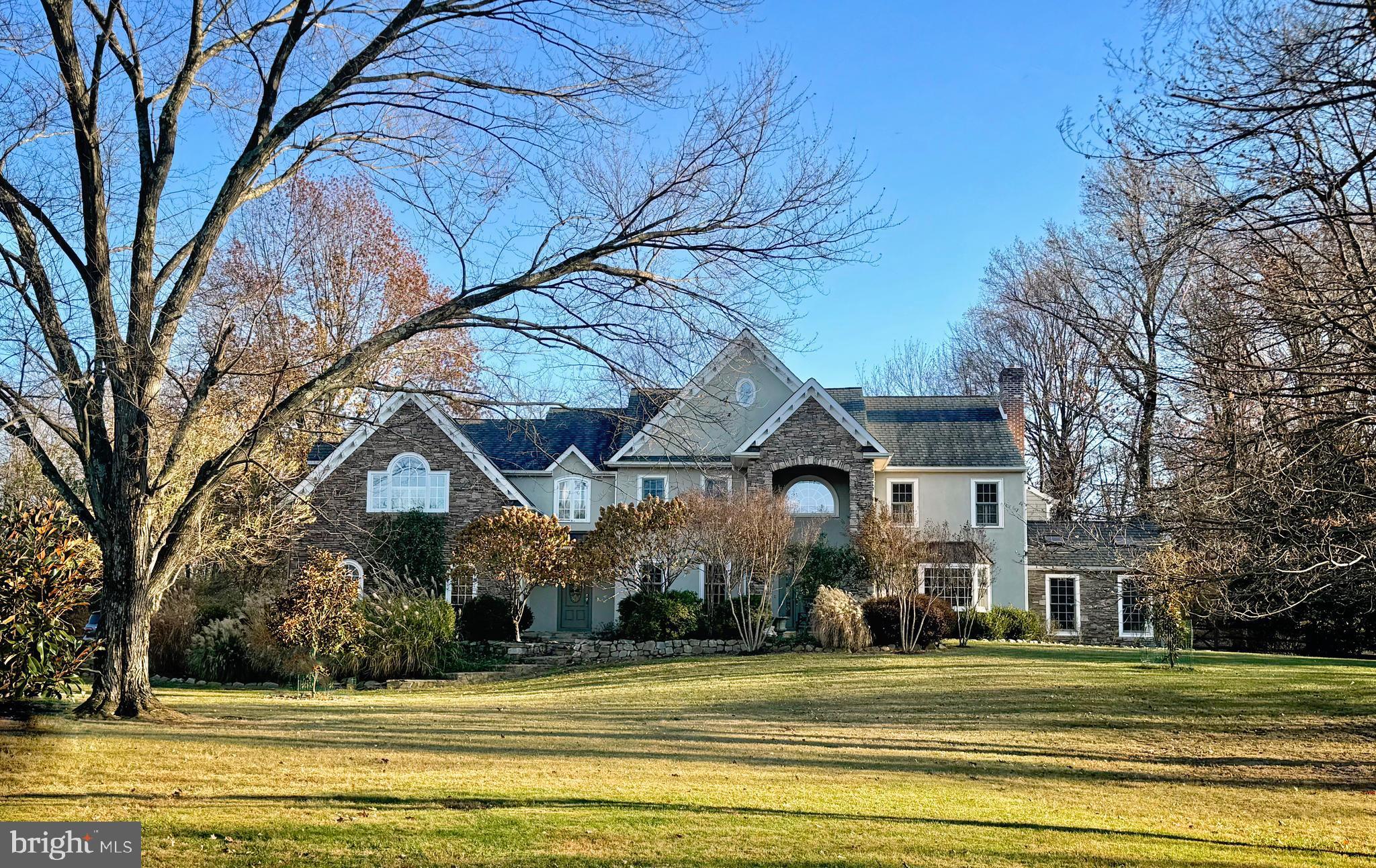 Stunning home, over 6,000 sq ft in White Gate in Wrightstown Township. Situated on over 4 acres, this custom home features 5 bedrooms, 5.5 baths, gourmet kitchen, stunning family room with coffered ceiling and fireplace, dining room with brick fireplace with raised hearth, and built ins. Exquisite woodworking with extensive use of crown molding, wainscoting, and enough built-ins to satisfy the most discriminating bibliophile. Kitchen features large island with drawer microwave, bar sink with filtered water faucet. Two dishwashers flank the hammered copper sink and the commercial range with double ovens allow for large scale entertaining. Large SubZero occupies the wall opposite the sink as well as a large pantry closet for storage. Four car oversized garage has access to the large laundry room with plentiful cabinetry, sink, granite counters, and large coat closet. The living room features a fireplace, large front bay window, french doors connecting to the family room and stunning hardwood flooring. The solarium, currently used as a secondary office has a cathedral ceiling with painted beams, skylights, built-ins, and plentiful windows. The primary office has pocket french doors leading to the kitchen, multiple built-ins and a subtle grass cloth wallpaper. The powder room has wainscoting as well as hardwood flooring, a new pedestal sink and has been freshly painted - as have most of the rooms in this expansive home.
The upper floor features 4 bedrooms, plus the spacious Primary Bedroom - featuring a 20' walk-in closet with built in cabinetry, fireplace, sitting room with access to a small balcony, built-ins flanking the french doors to the balcony, a large bath with Palladian window over the oversized jetted Jacuzzi, walk-in shower and connecting steam shower, as well as an additional dressing room with cabinetry. There are two additional hall baths, each with double vanities and a bedroom with en suite bath and walk in closet/dressing room. Additionally, there is a laundry room on this upper level. Finishing out the second floor is a library/study room with a full wall of built-ins, perfect for a quiet retreat for reading, studying or an extra office.
A full basement with outside entrance, features tile flooring with a faux wood grain, an additional room with full bath, walk in pantry, and mechanicals, including 2 200 am panels.
OPEN HOUSE CANCELED - OFFER ACCEPTED