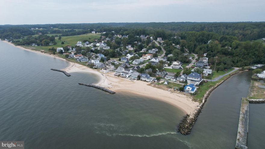 Welcome to 5115 Bay Parkway, an affordable vacation home and hidden coastal retreat tucked inside one of Huntingtown’s best kept secrets. Just about an hour from Washington, DC and Alexandria, this is where everyday life starts to feel like a getaway, without the hassle of Bay Bridge traffic.

Set within a charming waterfront community, this home offers access to a private neighborhood beach just a one minute walk from your door. Start your mornings with breathtaking sunrises over the Chesapeake Bay, spend your afternoons beachcombing for shark teeth, fossils, and sea glass, and wind down with moonrises over the water. From kayaking, paddle boarding, and fishing to simply parking a chair in the sand and relaxing, this is a place where life naturally slows down.

Nature lovers will feel right at home here, surrounded by the beauty of the shoreline and incredible wildlife, including herons, ospreys, bald eagles, shore birds, horseshoe crabs, and even otters. The community is golf cart friendly and offers some of the most desirable beach access in the area, along with a voluntary citizens association of just $65 per year, a community house for gatherings and events, and nearby Breezy Point Marina with slips and neighborhood access. The community also offers its own designated parking area with access to approximately 18 neighborhood boat slips.

Inside, the home blends thoughtful updates with easy, comfortable living. The kitchen was renovated in 2021, with additional improvements including windows and doors in 2022, HVAC and roof in 2020, and a whole house water filtration system. The sunroom is a standout space, offering gorgeous bay views and the perfect setting for morning coffee or a leisurely brunch. Outside, the back patio creates an ideal place to grill dinner and enjoy the sparkling water views as the day winds down.

The layout is simple and functional, making it ideal as a full time residence or weekend escape. There is also excellent practical storage for an active waterfront lifestyle, including a boat rack outside and basement space for kayaks, paddle boards, bikes, beach gear, and water sports equipment. A sump pump adds peace of mind and functionality to the lower level.

Beyond the neighborhood, outdoor recreation continues just minutes away. The American Chestnut Land Trust, about 10 minutes from the home, offers over 30 miles of scenic hiking trails through protected hardwood forest along Parkers Creek, making this a true paradise for bird watchers and nature enthusiasts.

You are also conveniently located just 15 minutes from the twin beach towns of North Beach and Chesapeake Beach, as well as Prince Frederick, and about 45 minutes to Solomons Island and Annapolis.

Whether you are looking to downsize, invest, or finally own an affordable beach house near DC, 5115 Bay Parkway is a rare opportunity to enjoy Chesapeake Bay living in a location many buyers have yet to discover.
Welcome to paradise!