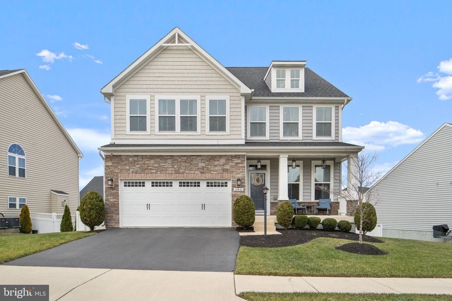 Discover the timeless elegance of this nearly new (built in 2019) 4-bedroom, 4.5-bathroom Colonial home at 12432 Mays Quarter Road in the sought-after Mays Quarter community of Woodbridge, VA. Spanning over 4,300 finished square feet across three levels, this open-concept residence combines modern luxury with thoughtful design and exceptional curb appeal, highlighted by a welcoming covered front porch and a two-car garage.

Step inside to gleaming wide-plank engineered hardwood floors flowing throughout the main level, where abundant natural light pours in through numerous windows and recessed lighting. The formal living and dining rooms set the stage for elegant gatherings, while the spacious family room—complete with a cozy gas fireplace—offers the perfect spot for relaxation. A versatile main-level room with double French doors serves ideally as a private office or exercise space.

At the heart of the home is the gourmet kitchen, designed for both everyday meals and entertaining. It features granite countertops, subway tile backsplash, 42" cabinets with under-cabinet lighting, a large center island with pendant lights, top-of-the-line stainless steel appliances (including gas cooking and double ovens), and a walk-in pantry. Adjacent is a convenient mudroom with custom built-ins, bench, and hooks, plus a powder room. Step out to the low-maintenance multi-level composite deck for seamless indoor-outdoor living!

Upstairs, the luxurious owner's suite awaits with dual walk-in closets and a spa-like bathroom boasting a soaking tub, separate shower, and dual vanity. Three additional spacious bedrooms each offer ample closet space, complemented by convenient bedroom-level laundry. A hallway nook with built-in cabinetry and countertops provides extra storage or a perfect homework station.

The walk-up lower level expands your living space with an expansive recreation room, media area, full bathroom, exercise or game room (bonus room), rough-in for a wet bar, and generous storage/utility room—ideal for a home theater, play area, or guest suite.

Residents of Mays Quarter enjoy resort-style amenities, including a clubhouse with community room and fitness center, outdoor swimming pool, tennis courts, basketball courts, tot lots/playground, and jogging paths. Golf lovers will appreciate the proximity to Old Hickory Golf Course, while everyday conveniences abound with Stonebridge at Potomac Town Center, shopping, restaurants, grocery stores, hospitals, and I-95 just minutes away. Zoned for highly regarded Colgan High School.

Don't miss this exceptional opportunity to own a move-in-ready home blending comfort, style, and convenience. Schedule your private tour today!